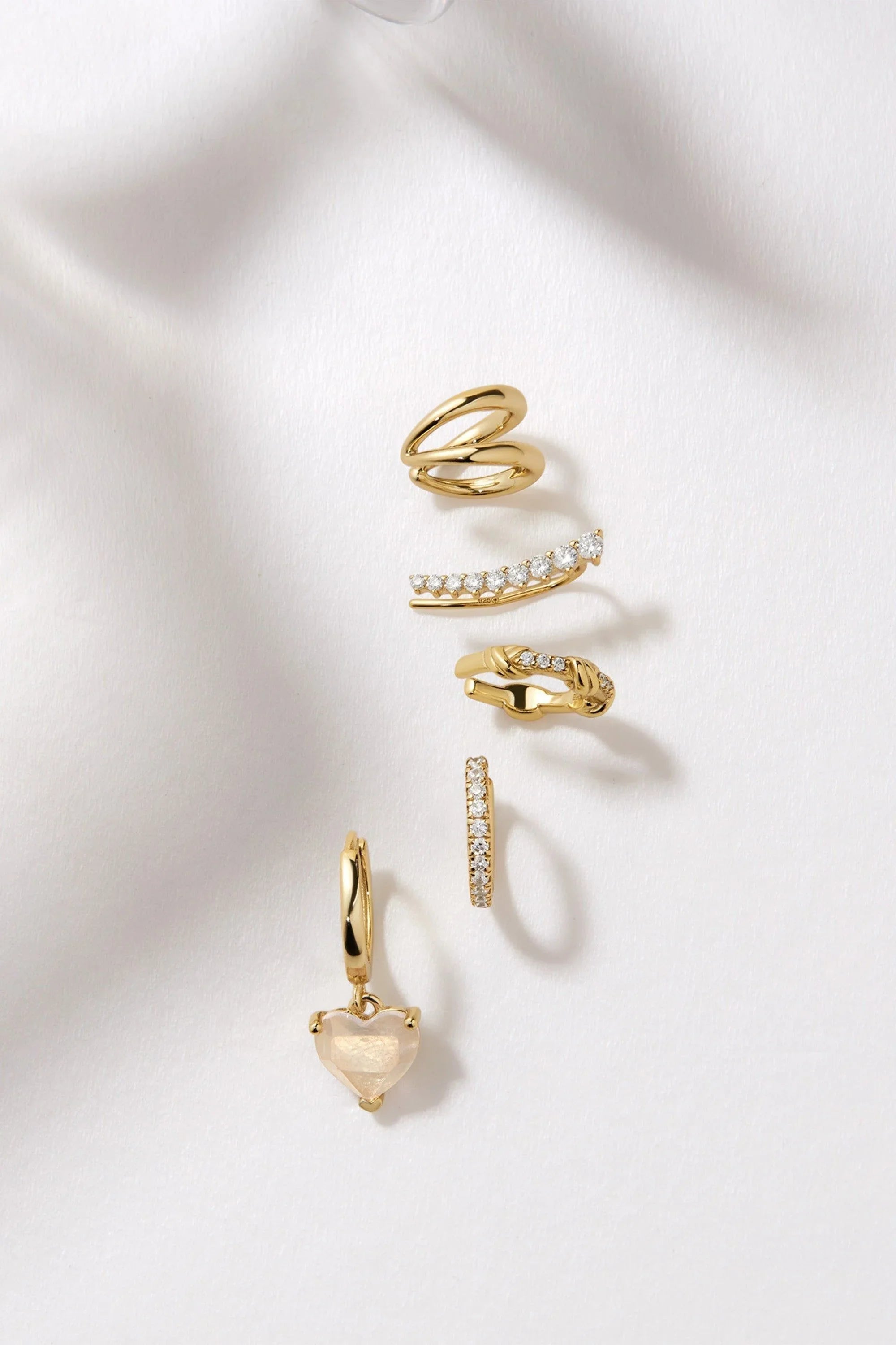 Gold-toned earrings and ear cuffs from the Graduated CZ Bar Ear Crawl jewelry set
