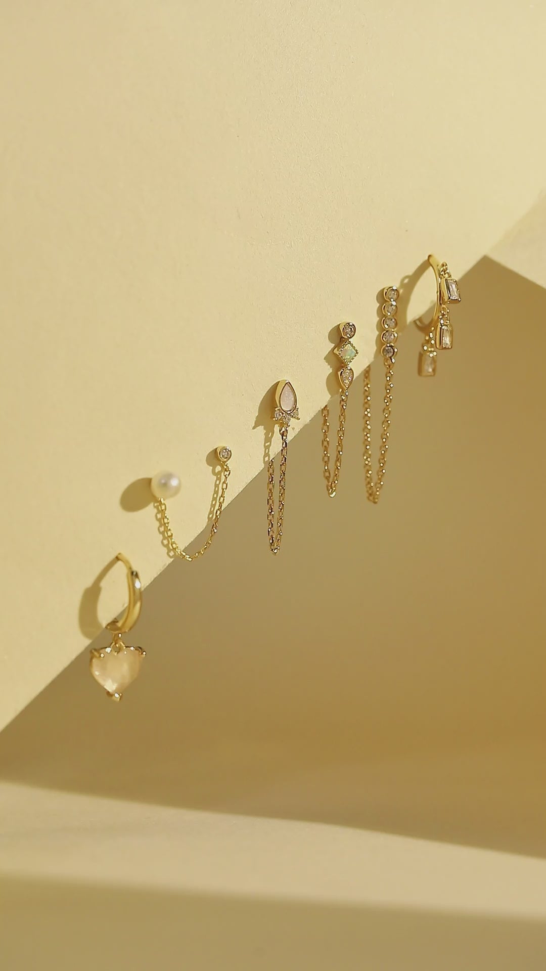 a row of earrings sitting on top of a shelf