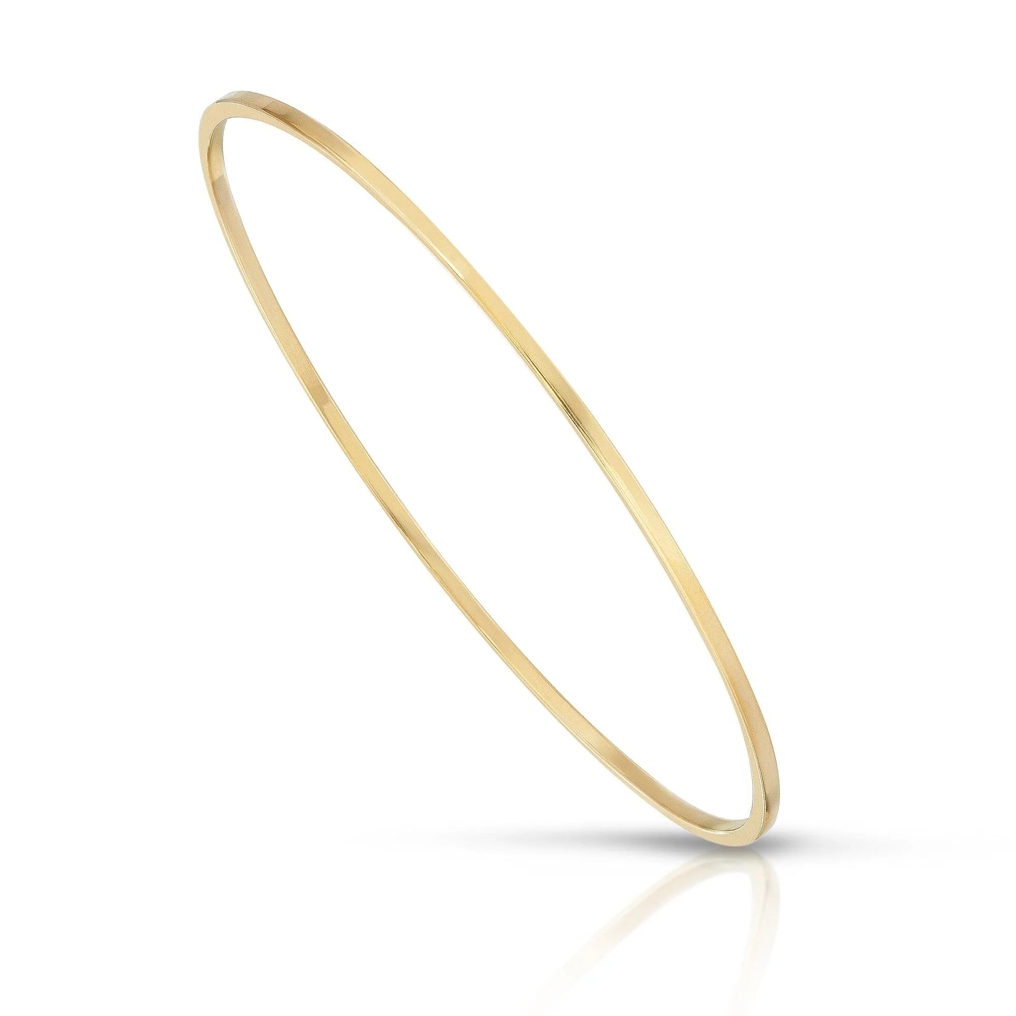 Thin gold bangle showcasing the Skinny Stella Bangle crafted from brass wire