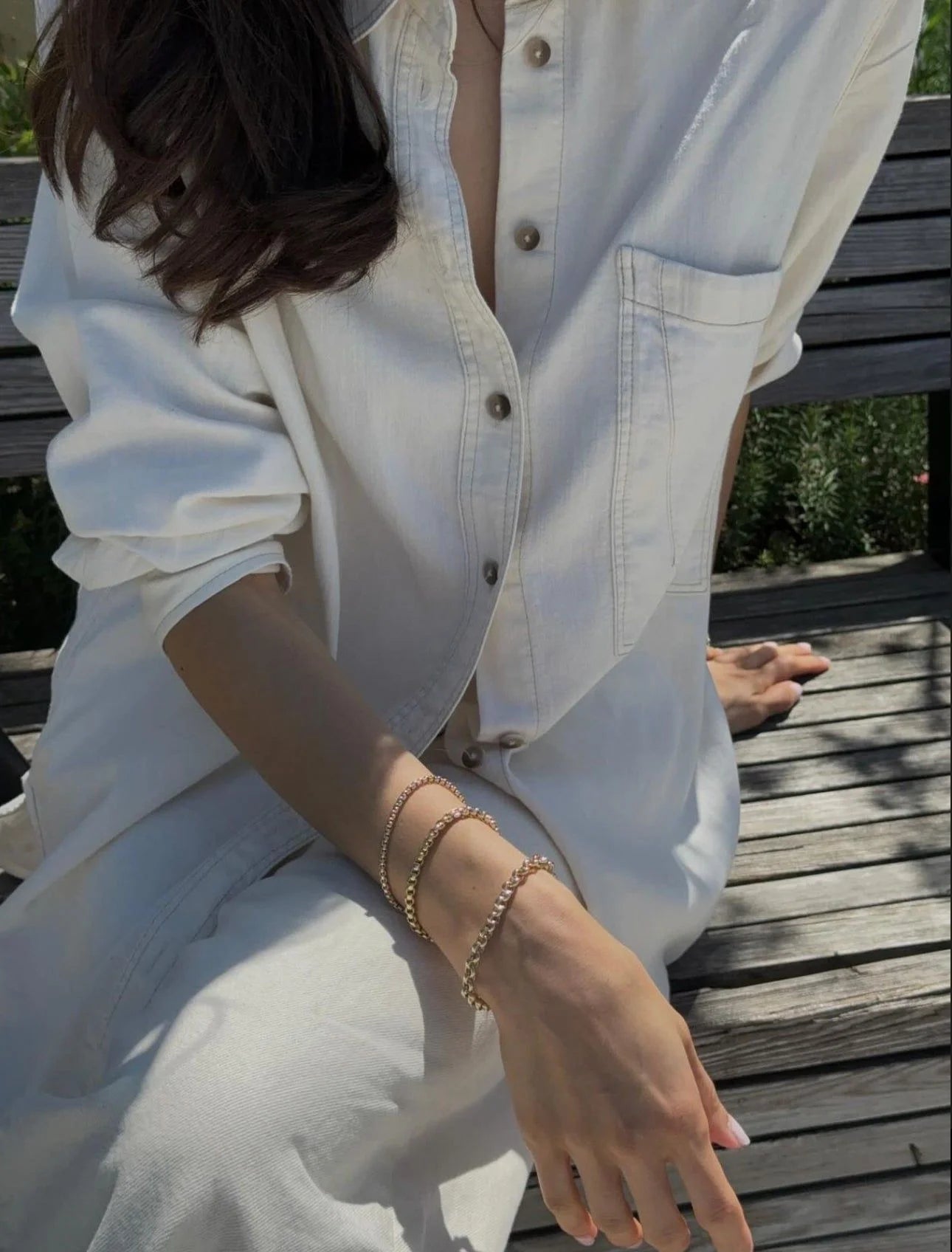 Cream-colored button-down jumpsuit with Thin Luciana Bracelet featuring recycled brass Venetian and brass Venetian box chain