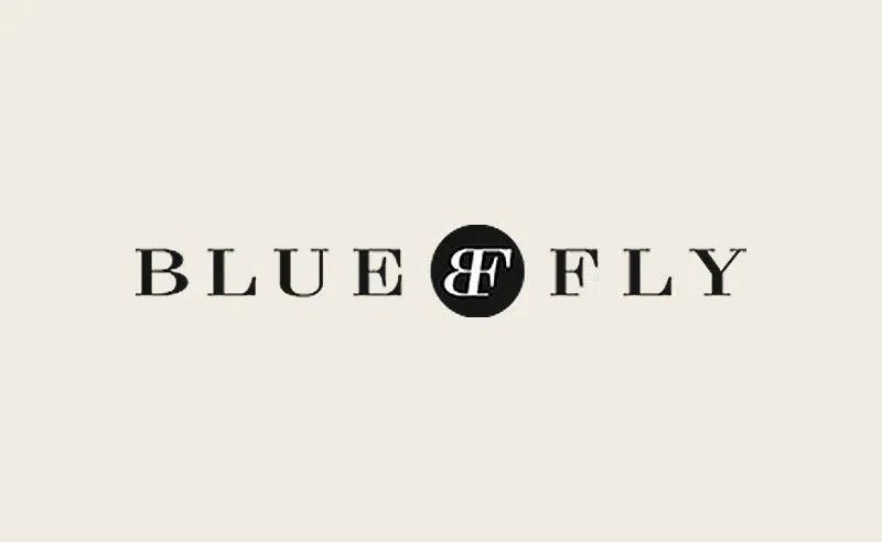 Blue Fly logo displayed in an article about Eklexic as a Rising Star on Bluefly.com