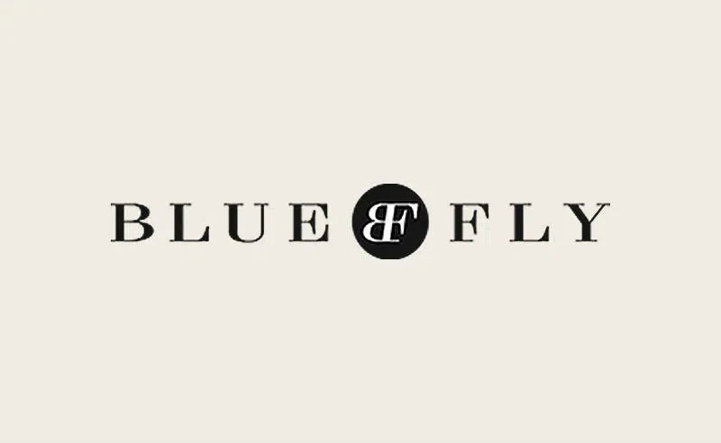 Blue Fly logo displayed in an article about Eklexic as a Rising Star on Bluefly.com
