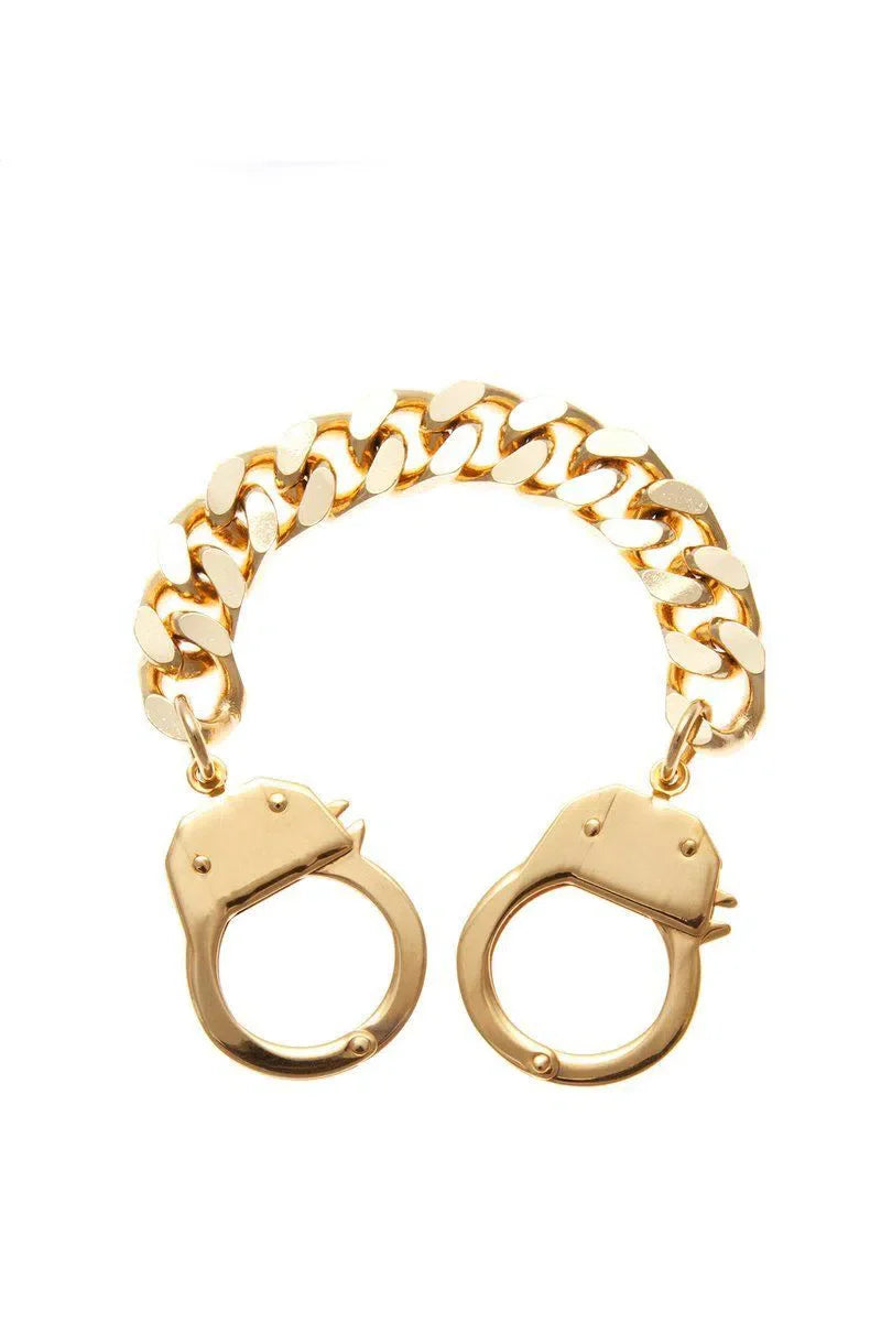 Gold handcuff bracelet worn by Sophia Bush in April 2014, showcasing Eklexic style.