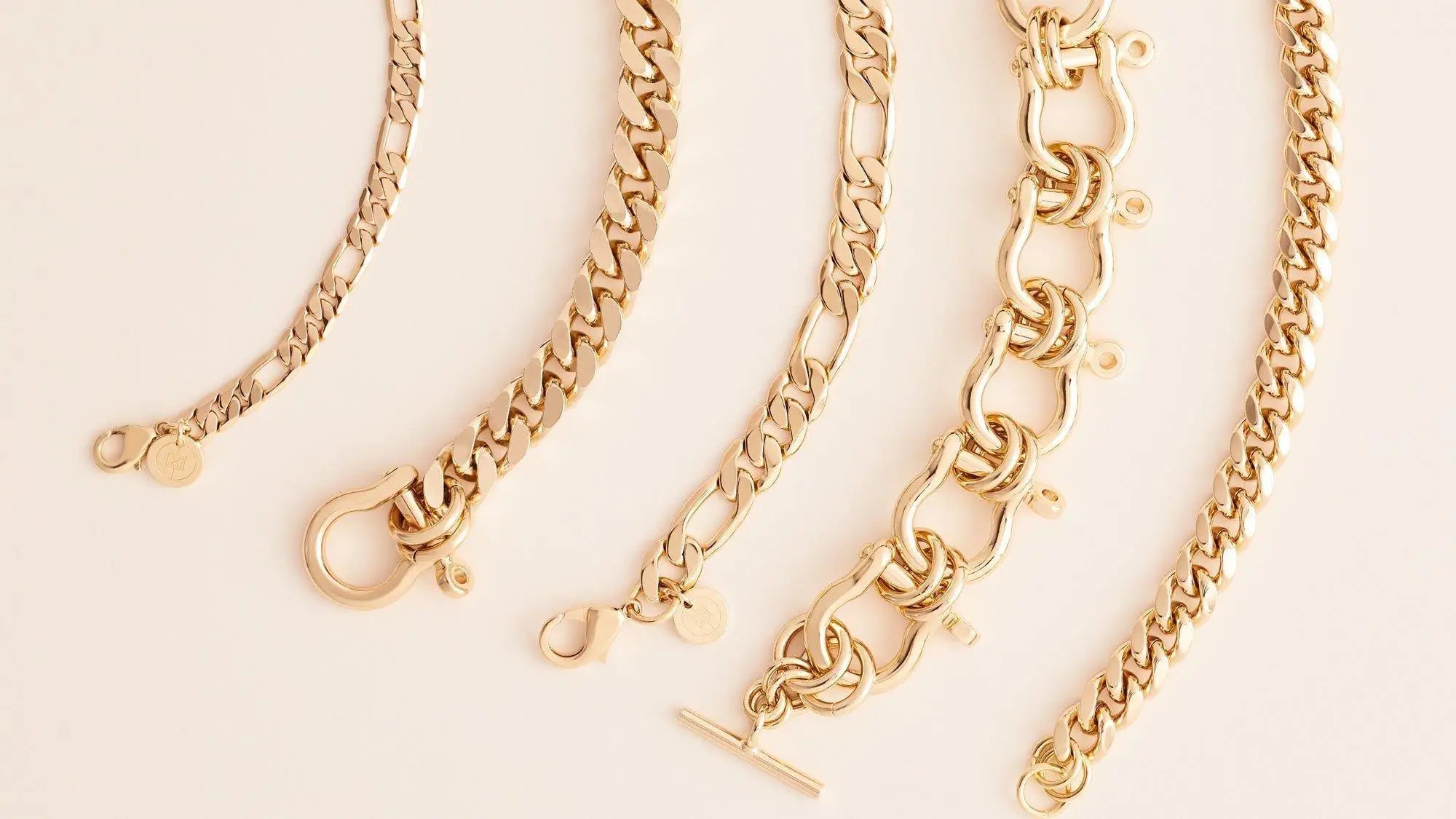 Five gold-toned link chain anklets in a stylish collection of elongated link chains.