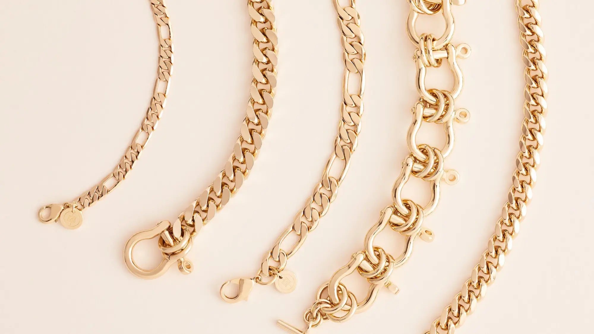 Assorted gold chain bracelets including link chain and elongated link designs.