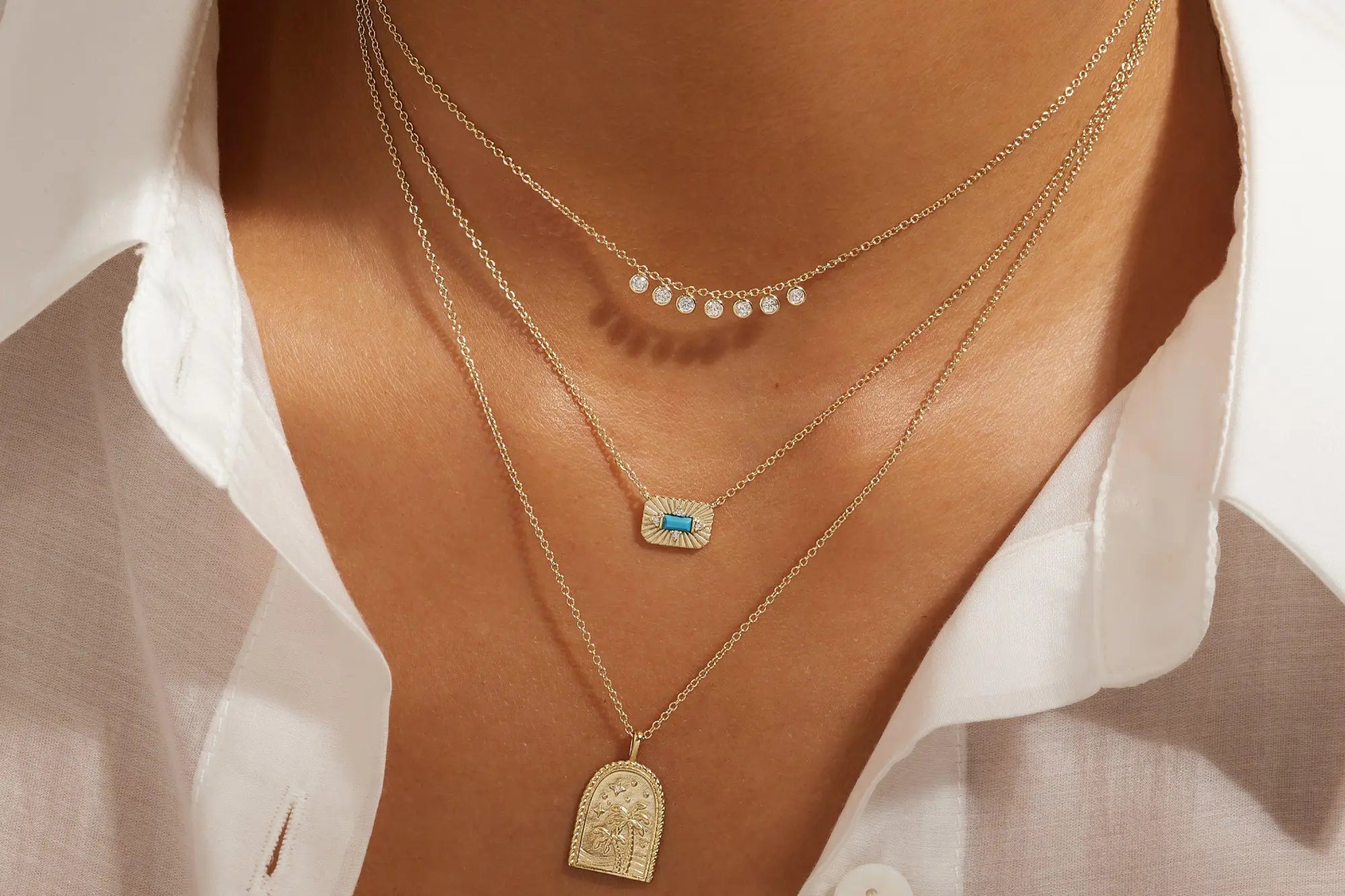 Layered gold necklaces from the Layered Necklaces collection displayed elegantly