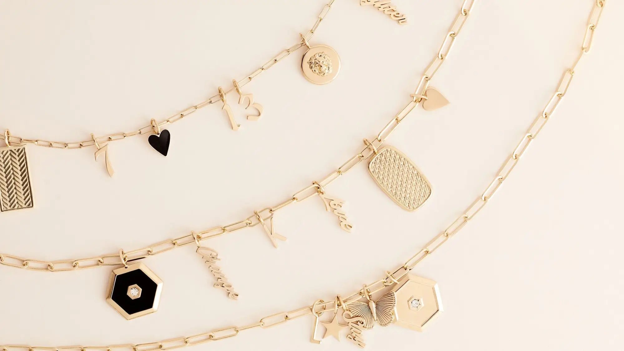 Gold charm necklaces from the Charms & Pendants collection beautifully showcased