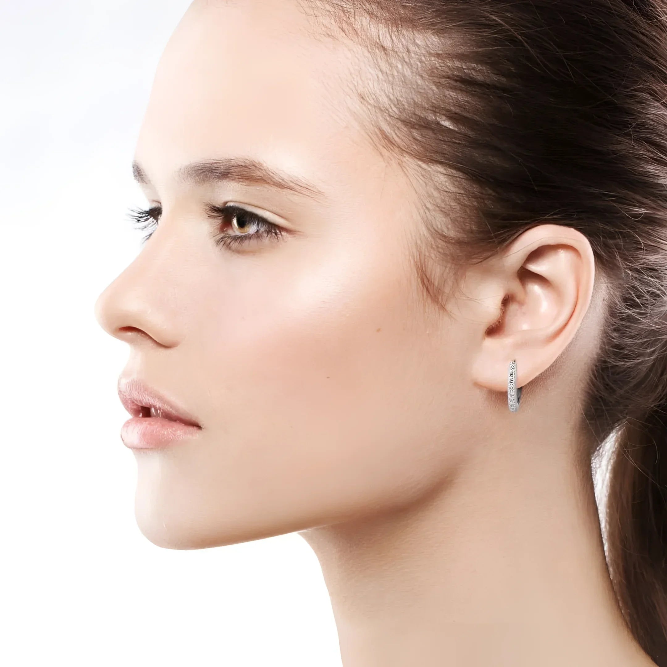 Woman wearing hoop earrings in 14k white gold from fine jewelry collection