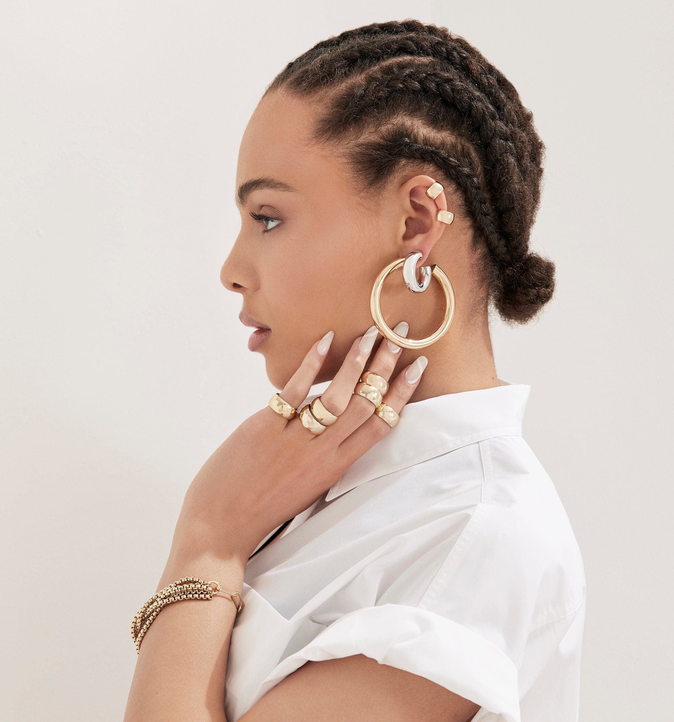 Woman showcasing recycled brass hollow Ryan Hoops and elegant gold jewelry