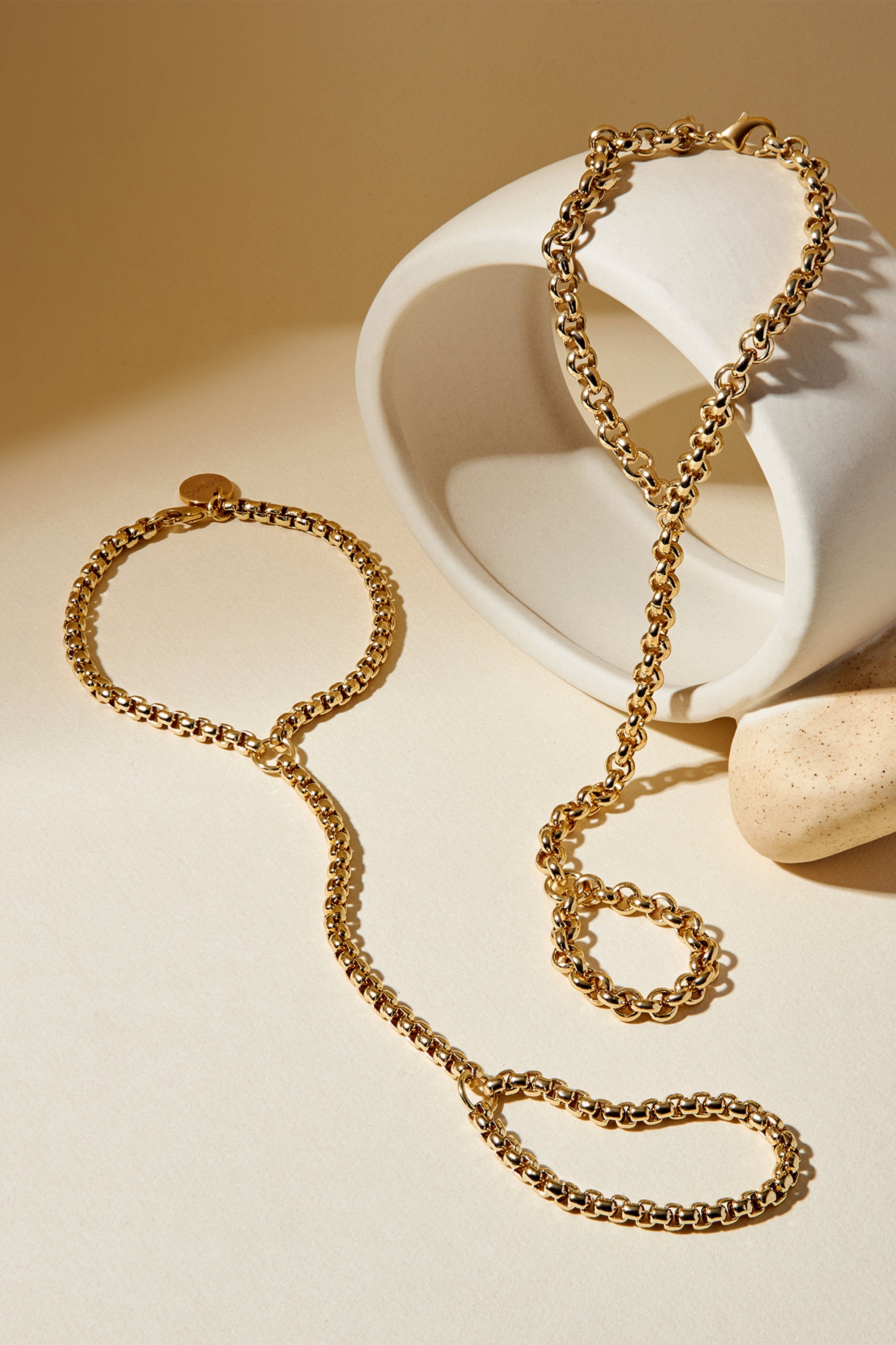 Gold-toned chain jewelry set from Raya Hand Chain looks stylish and trendy for any occasion