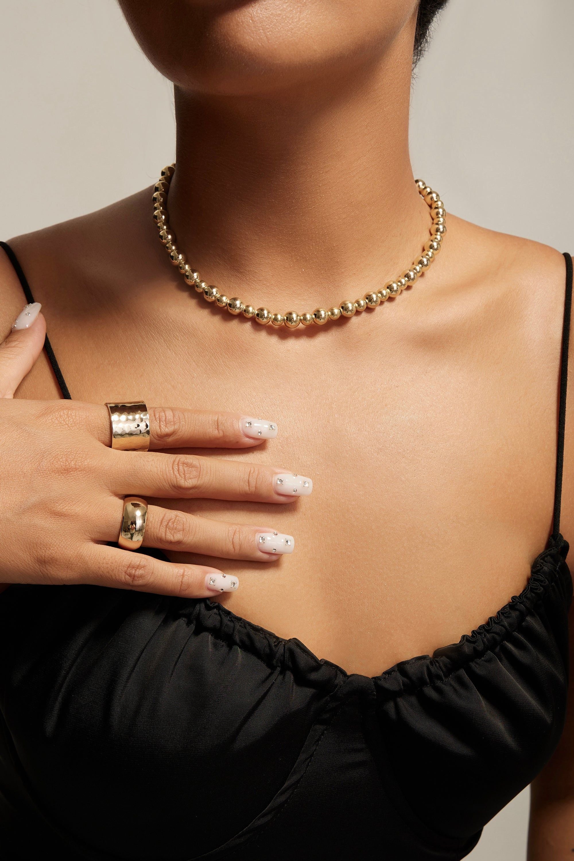 Gold beaded necklace paired with 9.5mm Domed Ring in 14k yellow gold finish