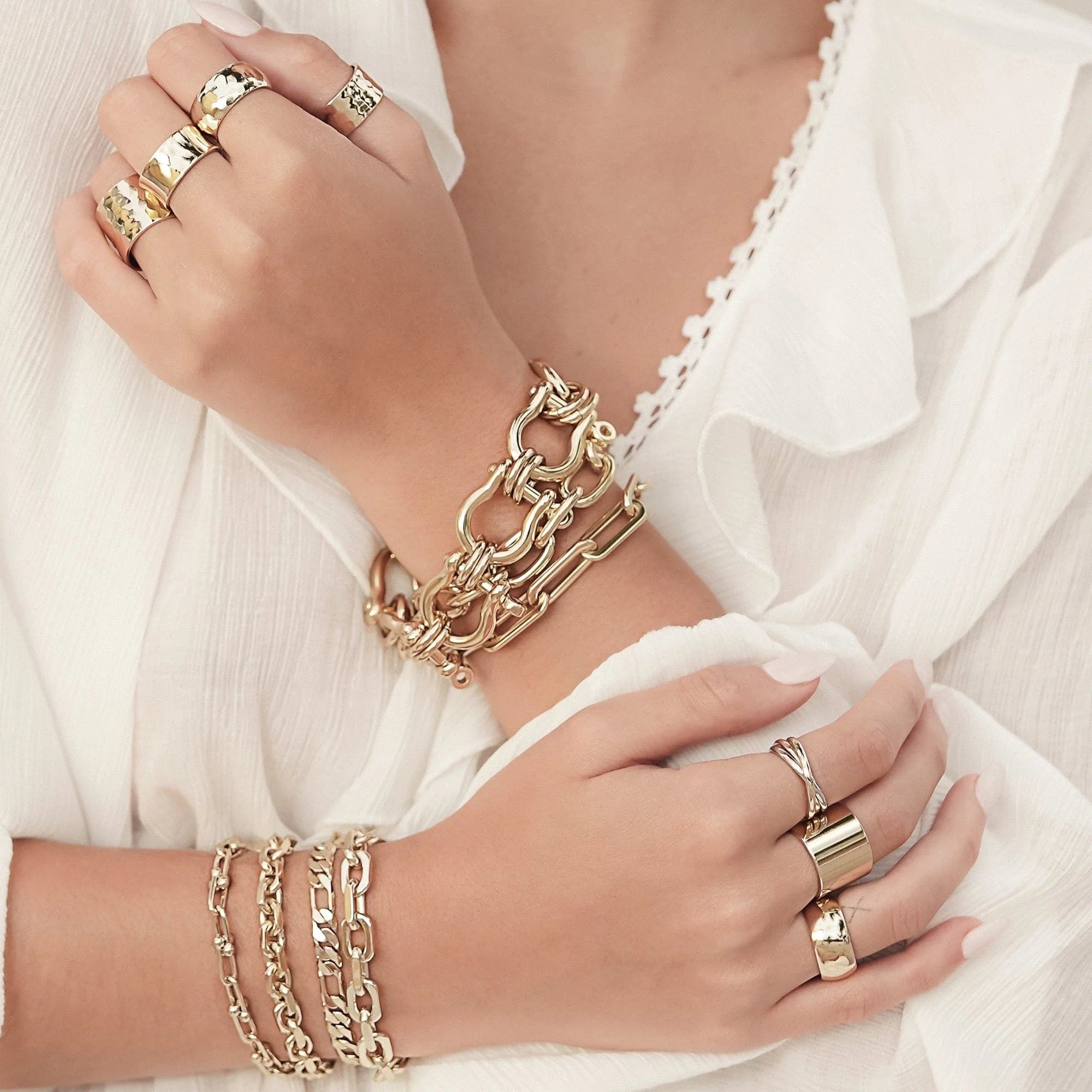 Gold jewelry on hands featuring a 9.5mm hammered wide recycled brass ring