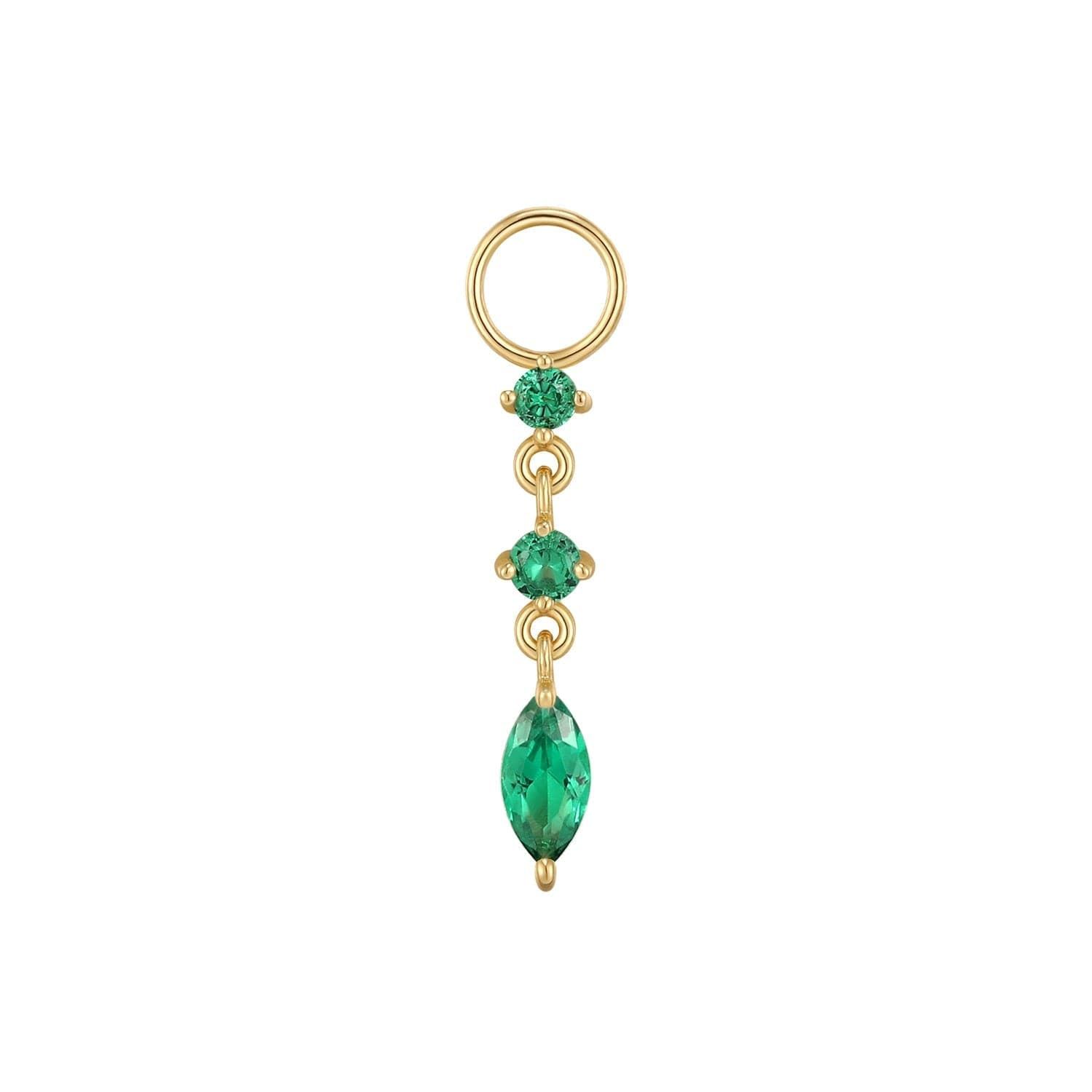 a gold ring with a green stone hanging from it