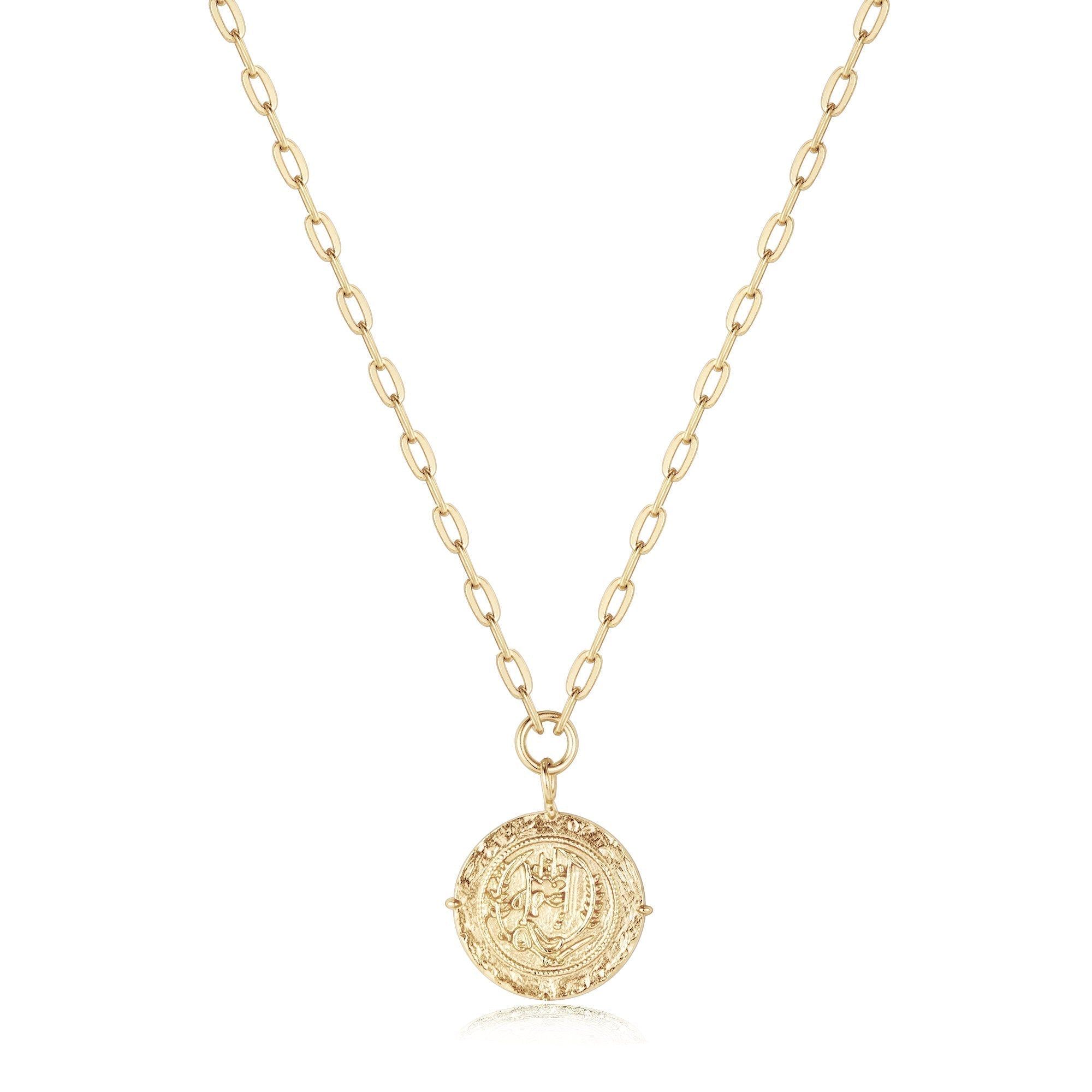 a gold necklace with a coin on a chain