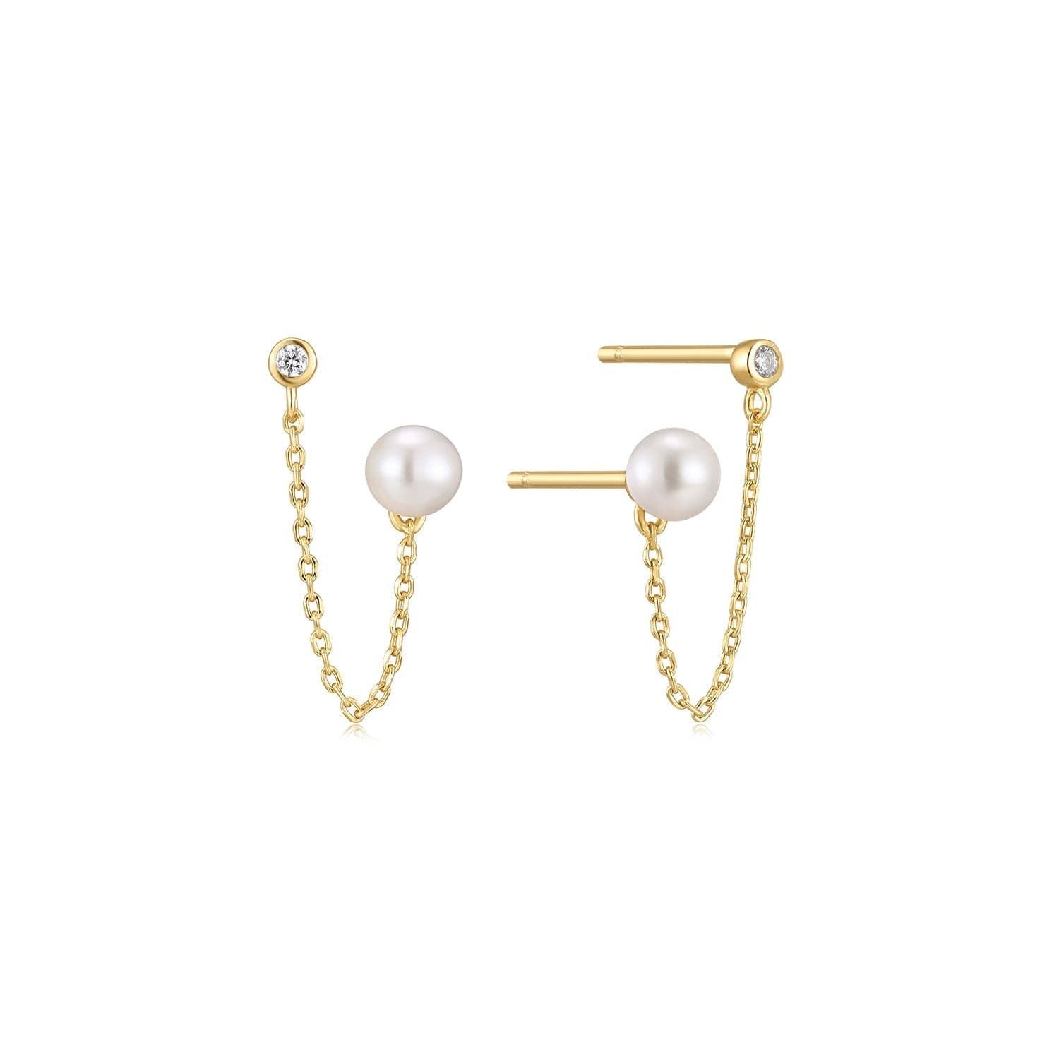 a pair of earrings with pearls and a chain