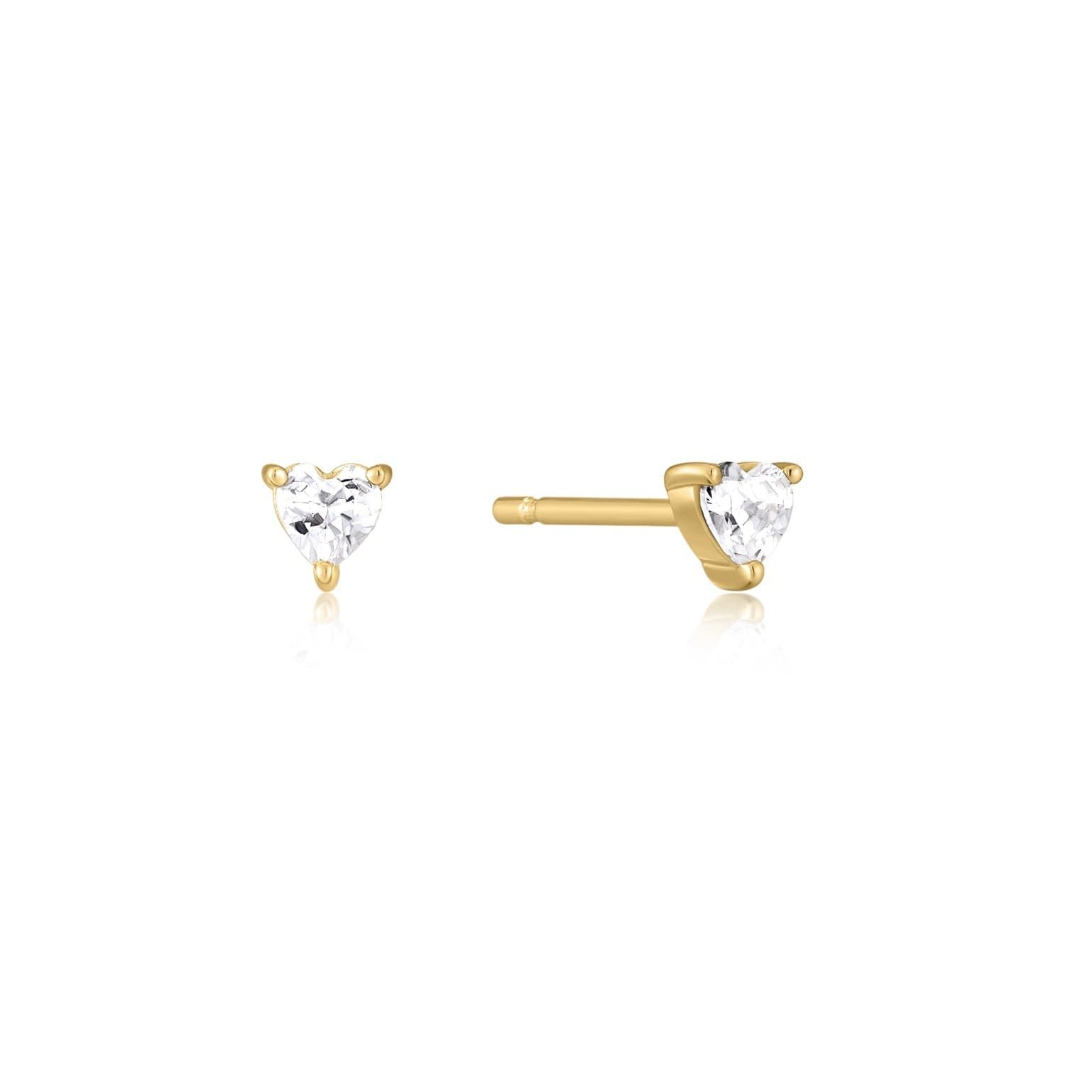 a pair of gold earrings with a single diamond