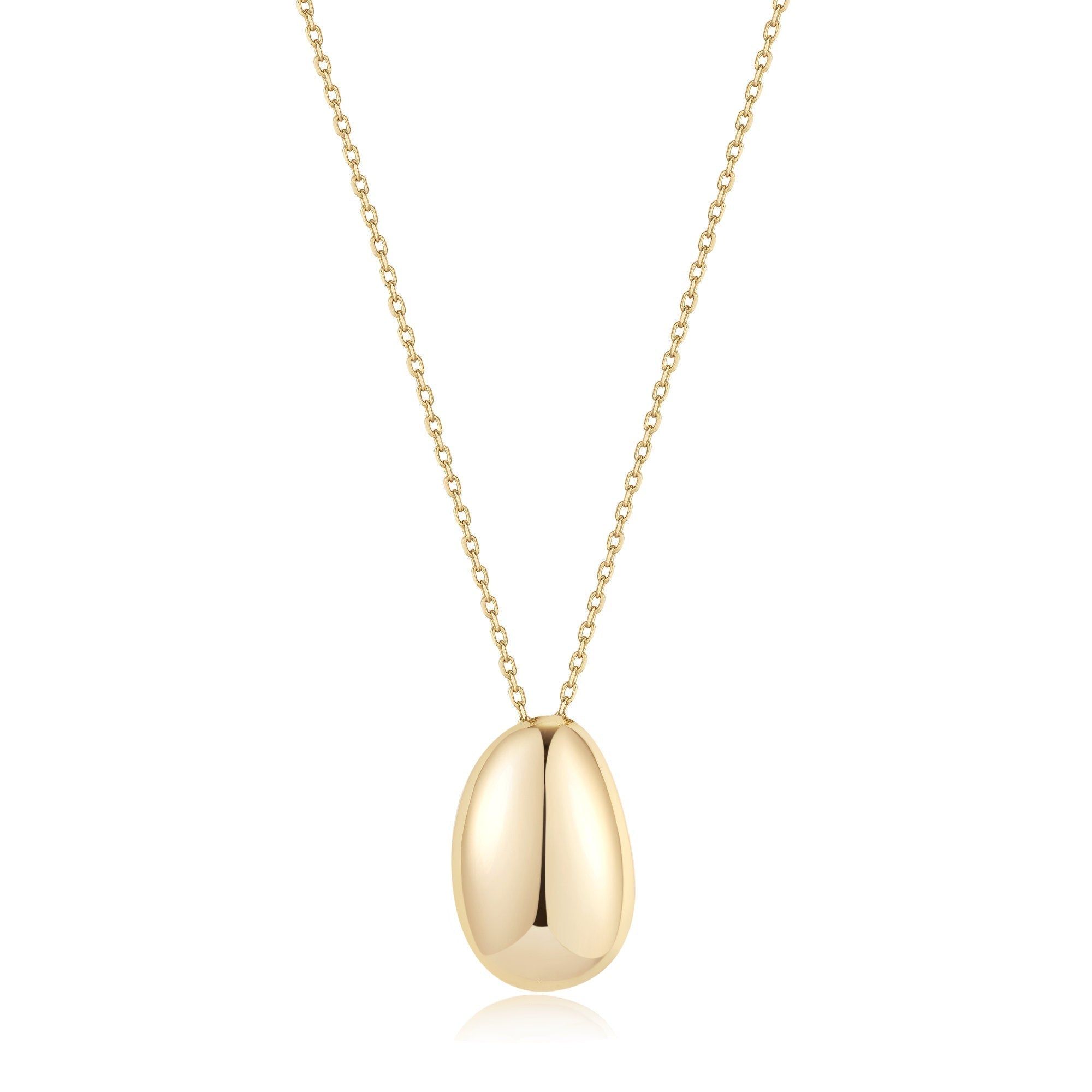 a gold necklace with an oval shaped pendant