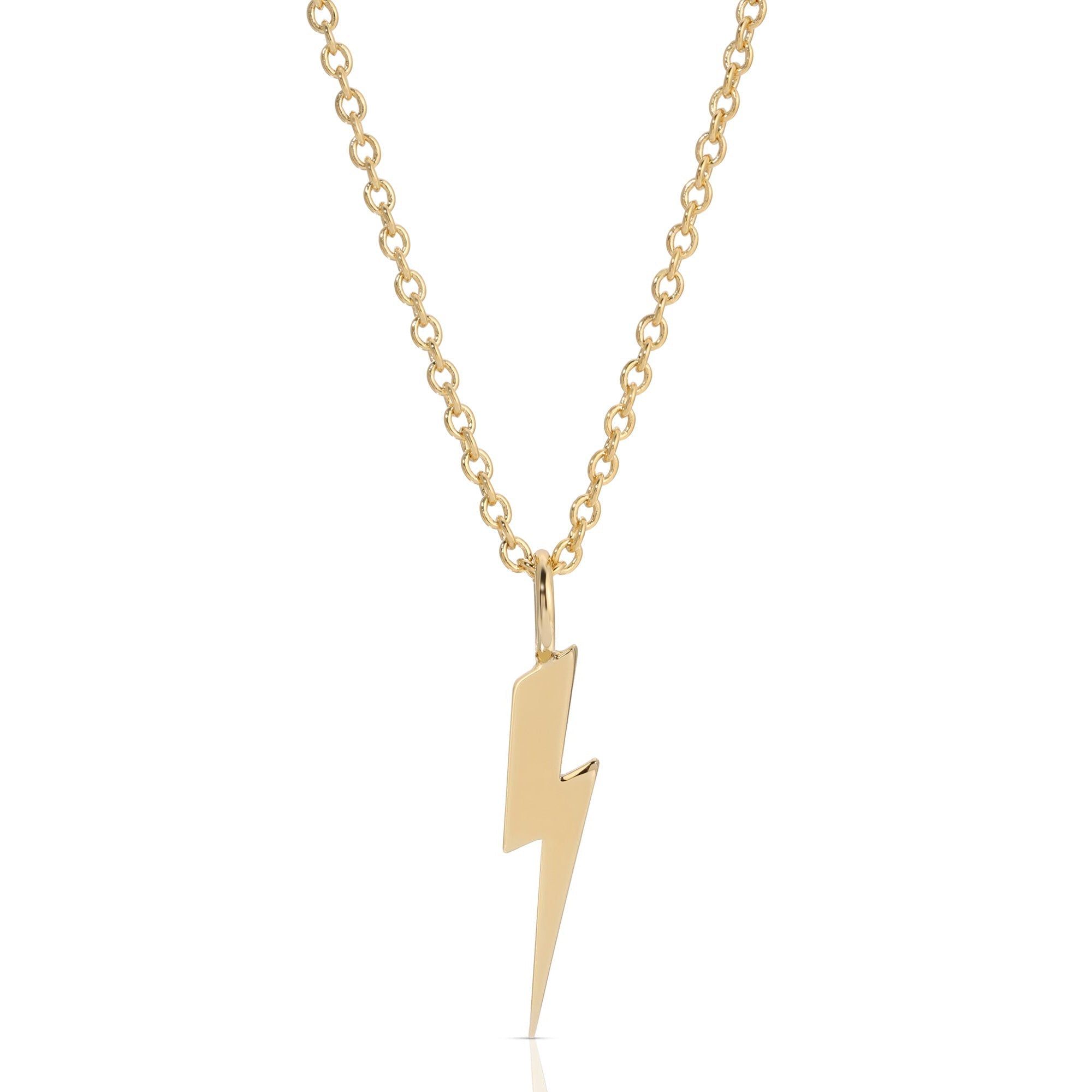 a gold necklace with a lightning bolt on it