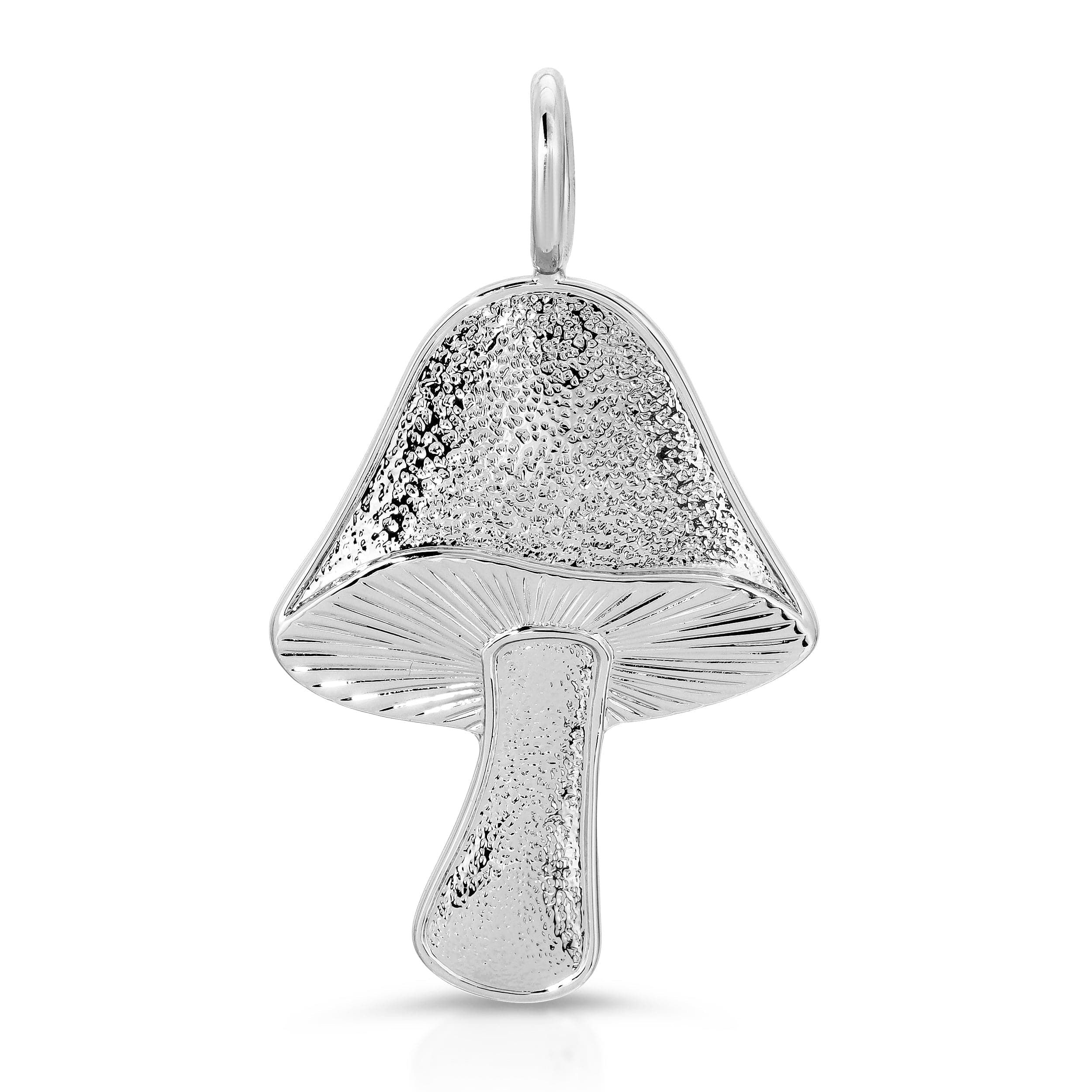a silver pendant with a mushroom on it