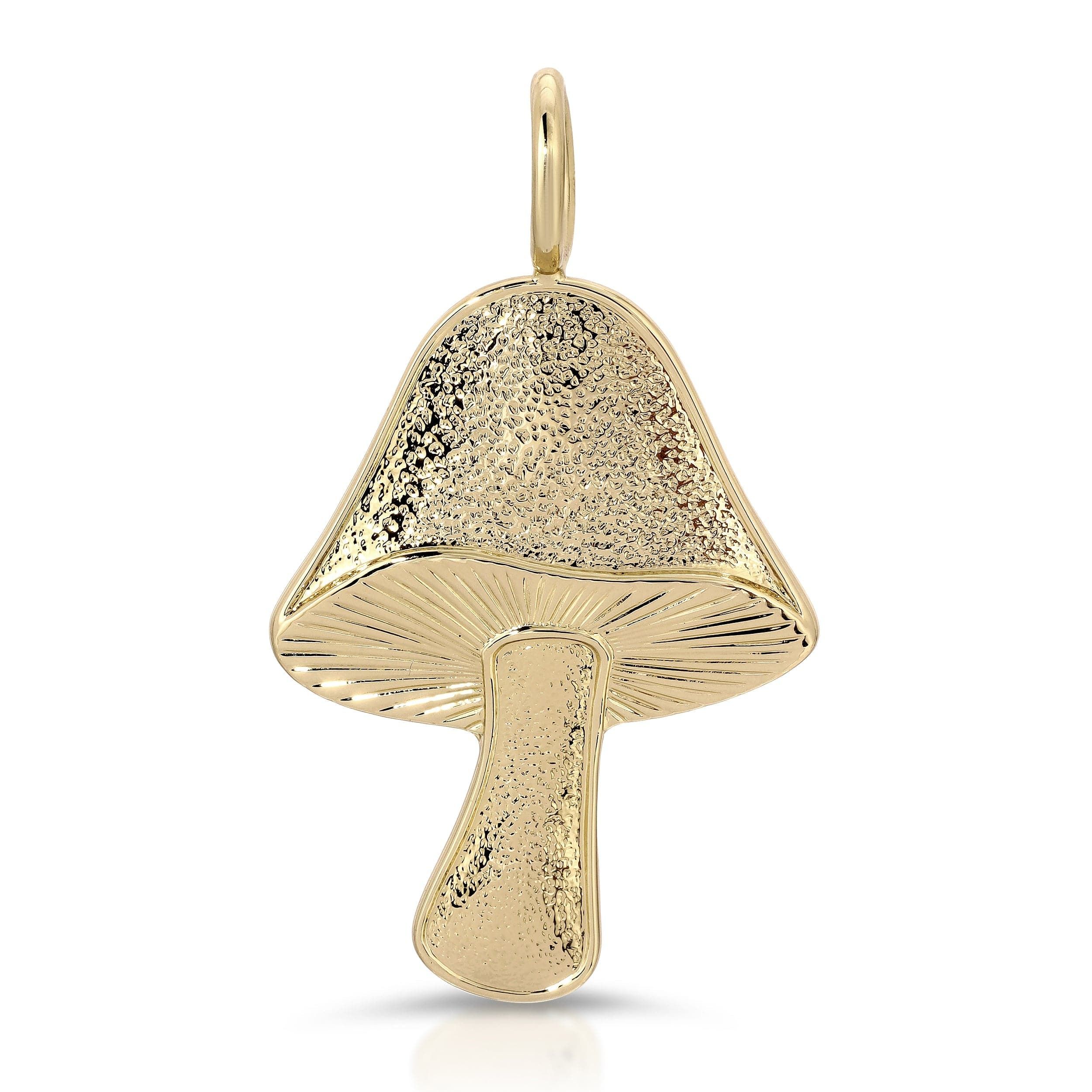 a gold pendant with a mushroom on it