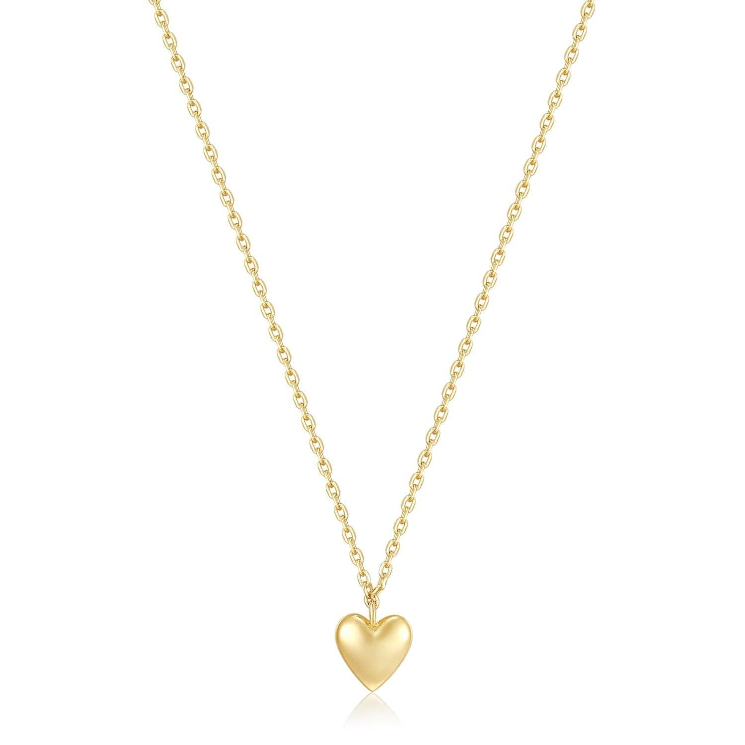 a gold heart necklace on a white background