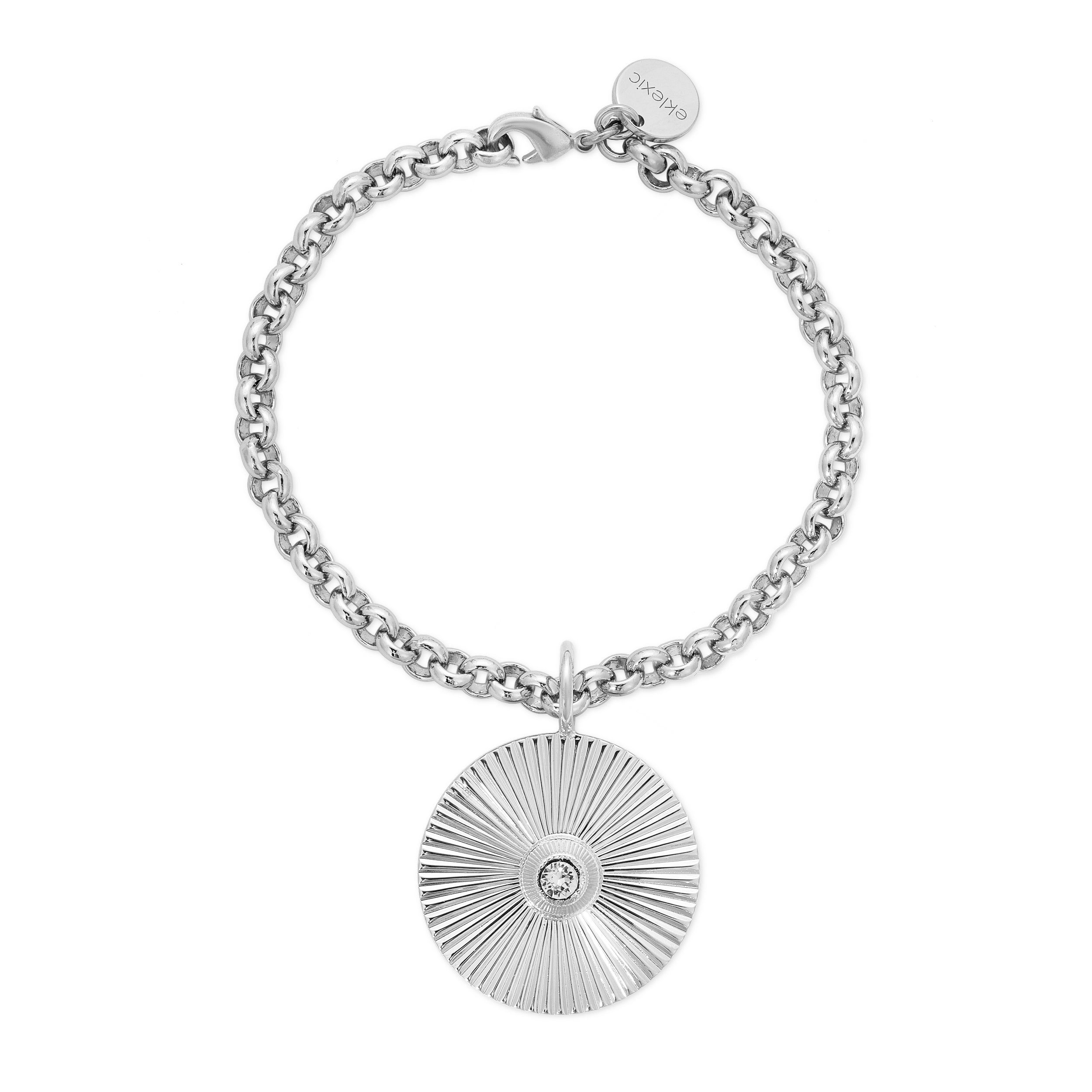 a silver bracelet with a disc charm