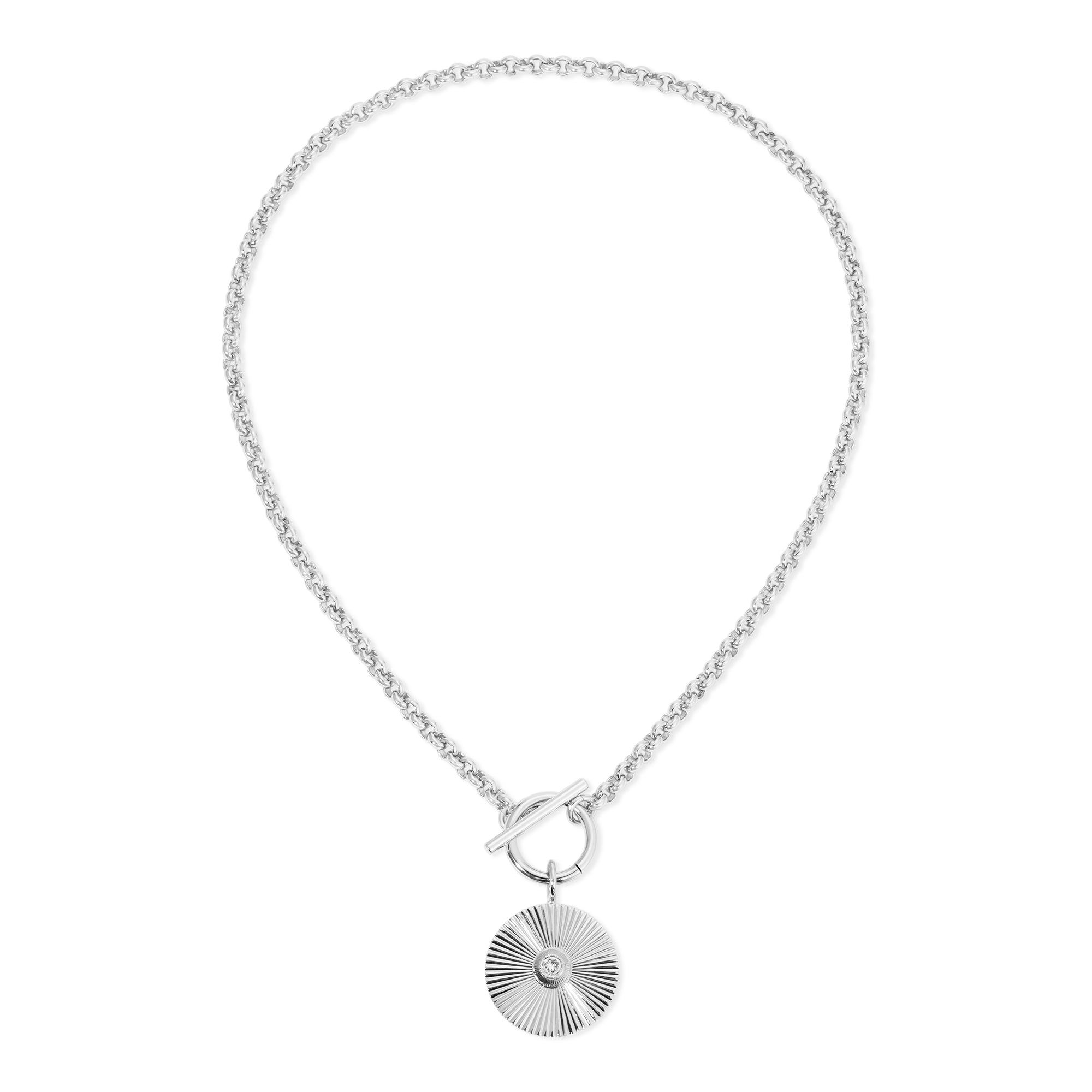 a silver necklace with a shell charm