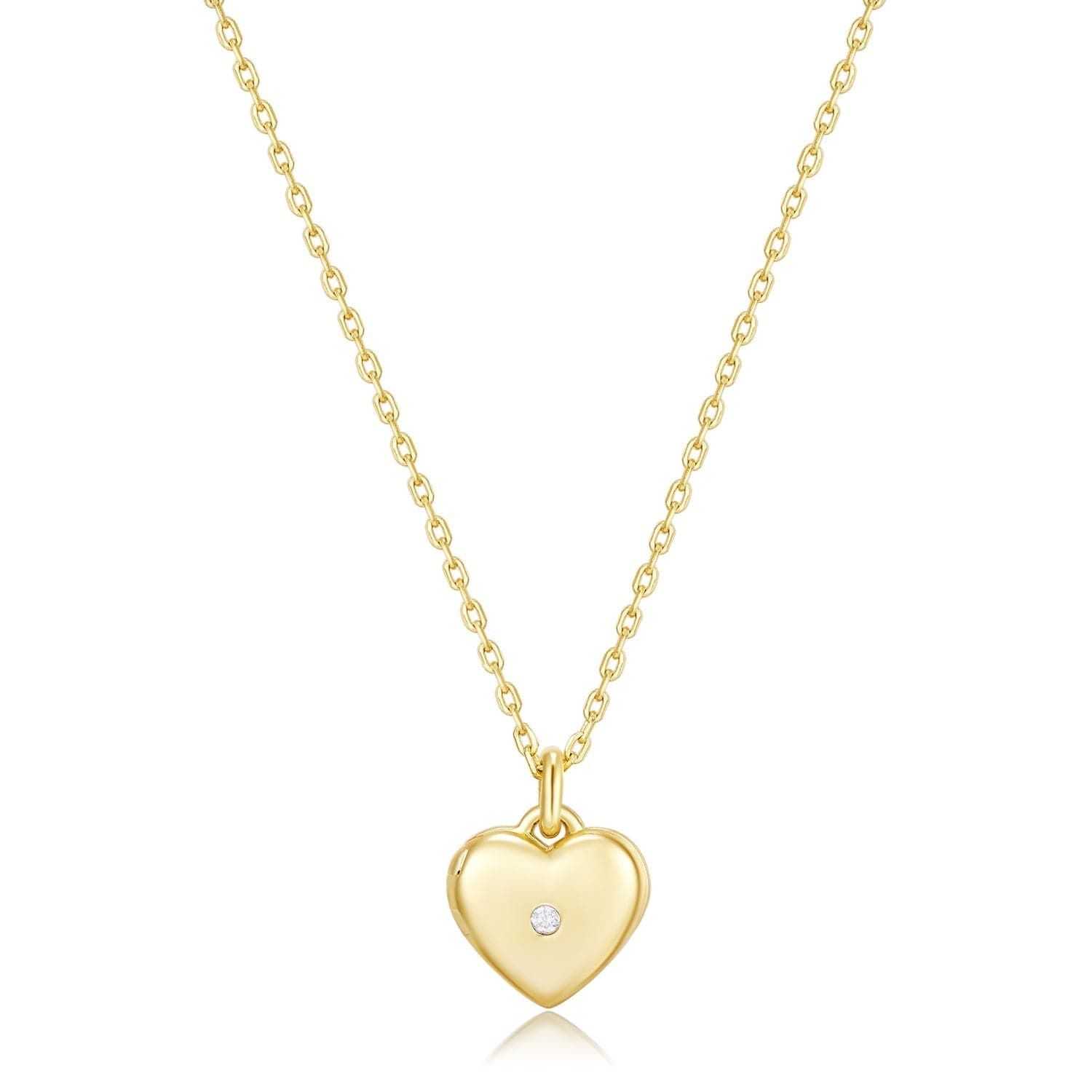 a gold heart necklace with a diamond in the center