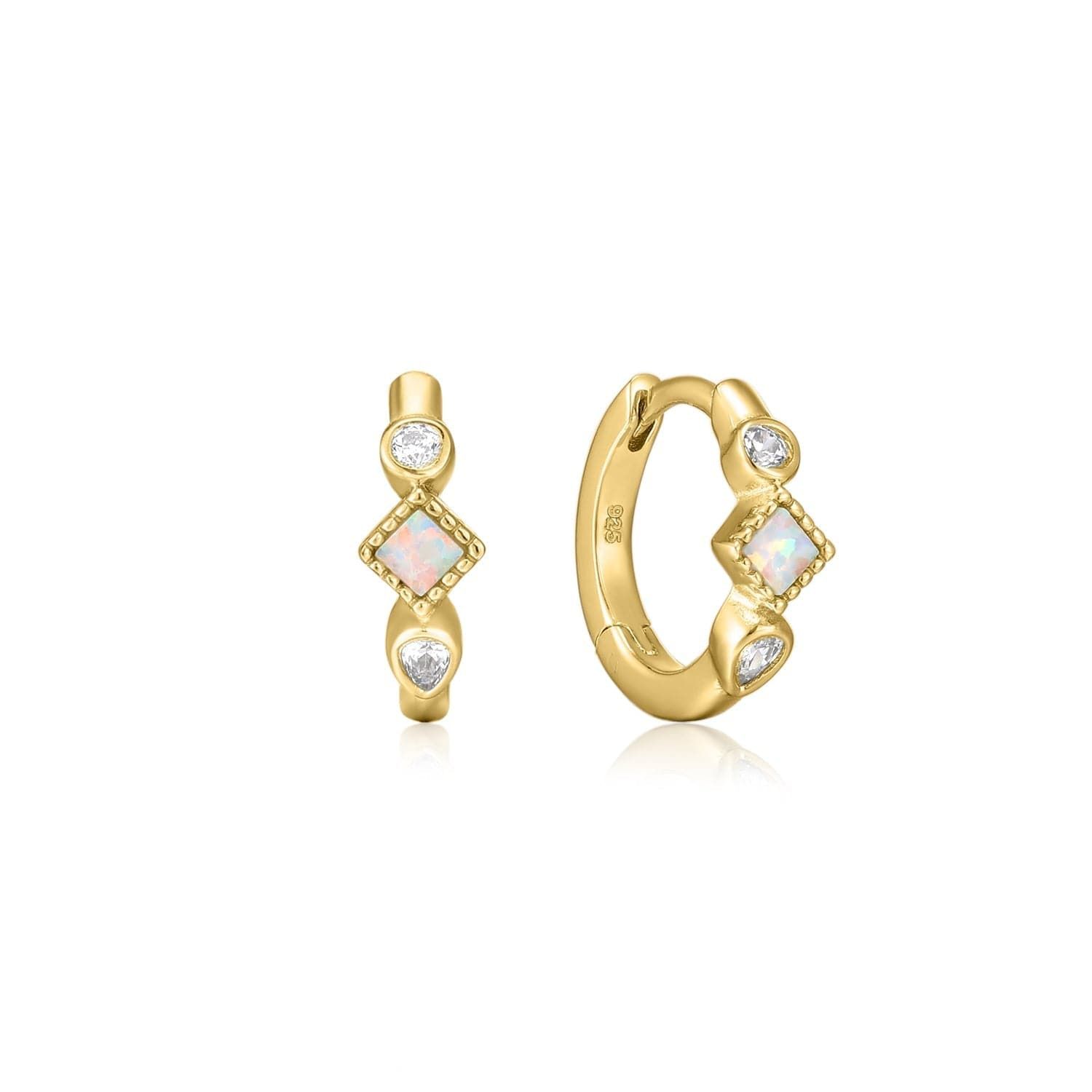 a pair of gold hoop earrings with white stones