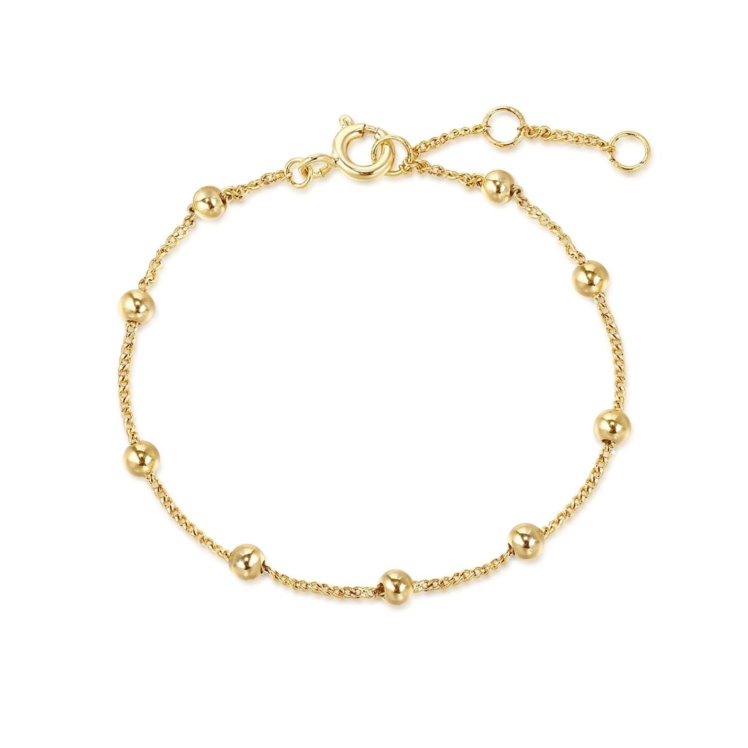 a gold beaded bracelet on a white background
