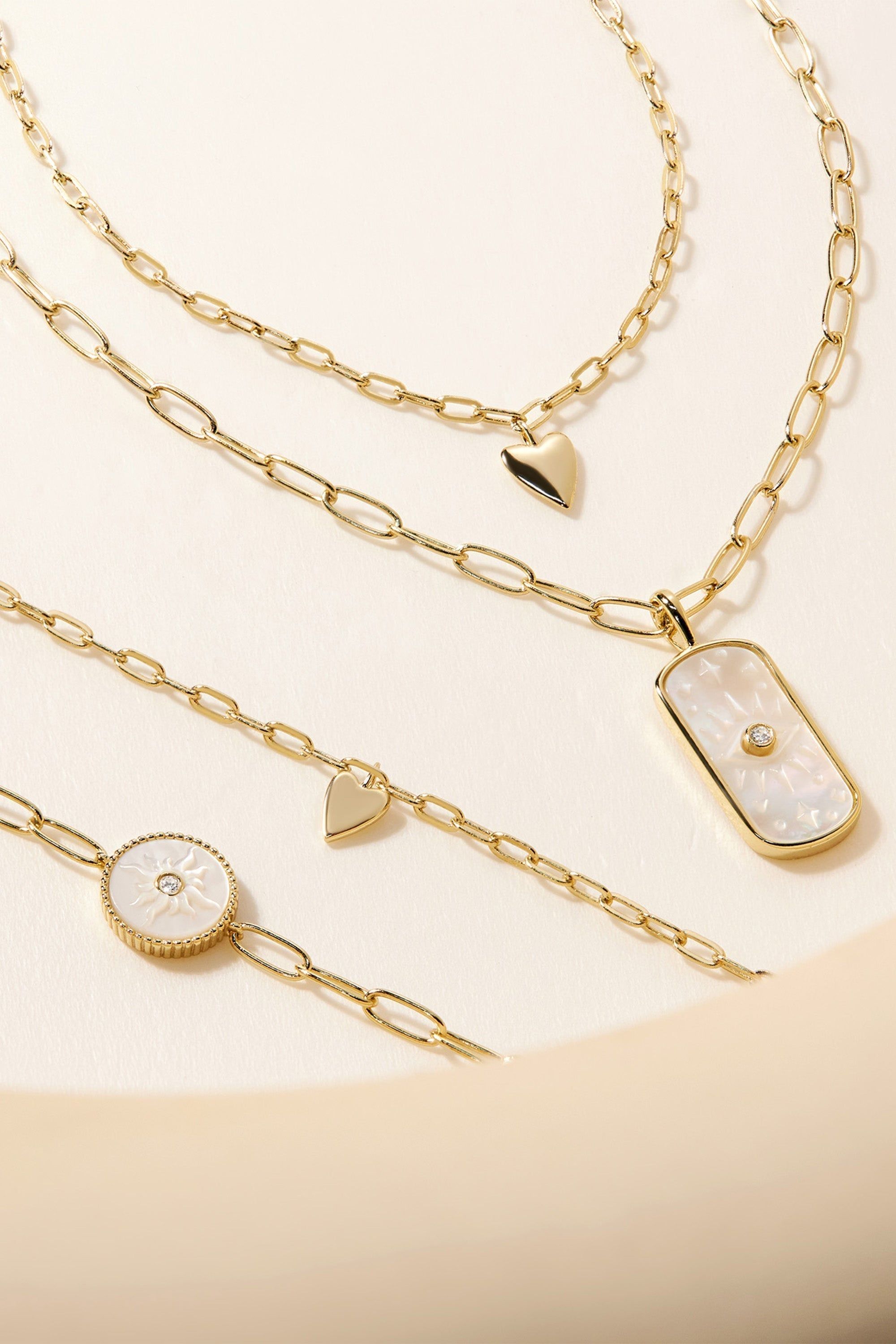 a collection of necklaces on a white surface