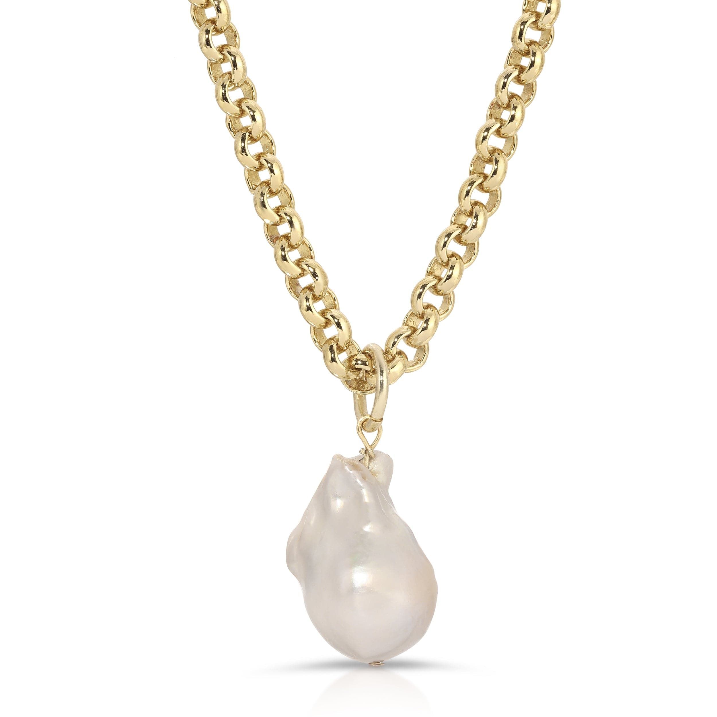 a necklace with a large white pearl hanging from it