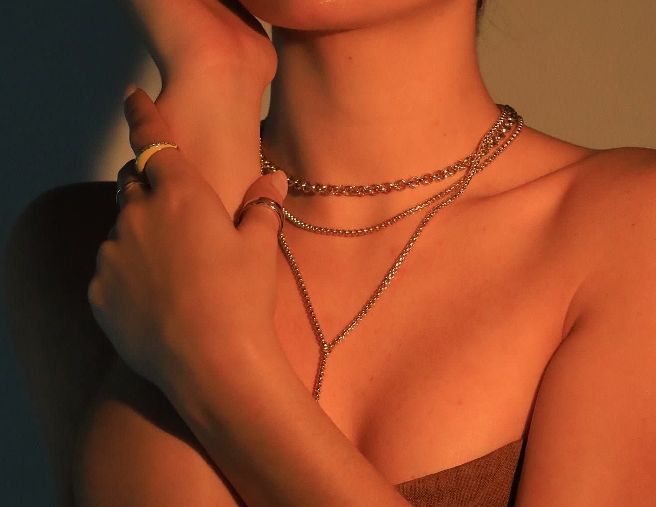 a woman wearing a necklace and a ring