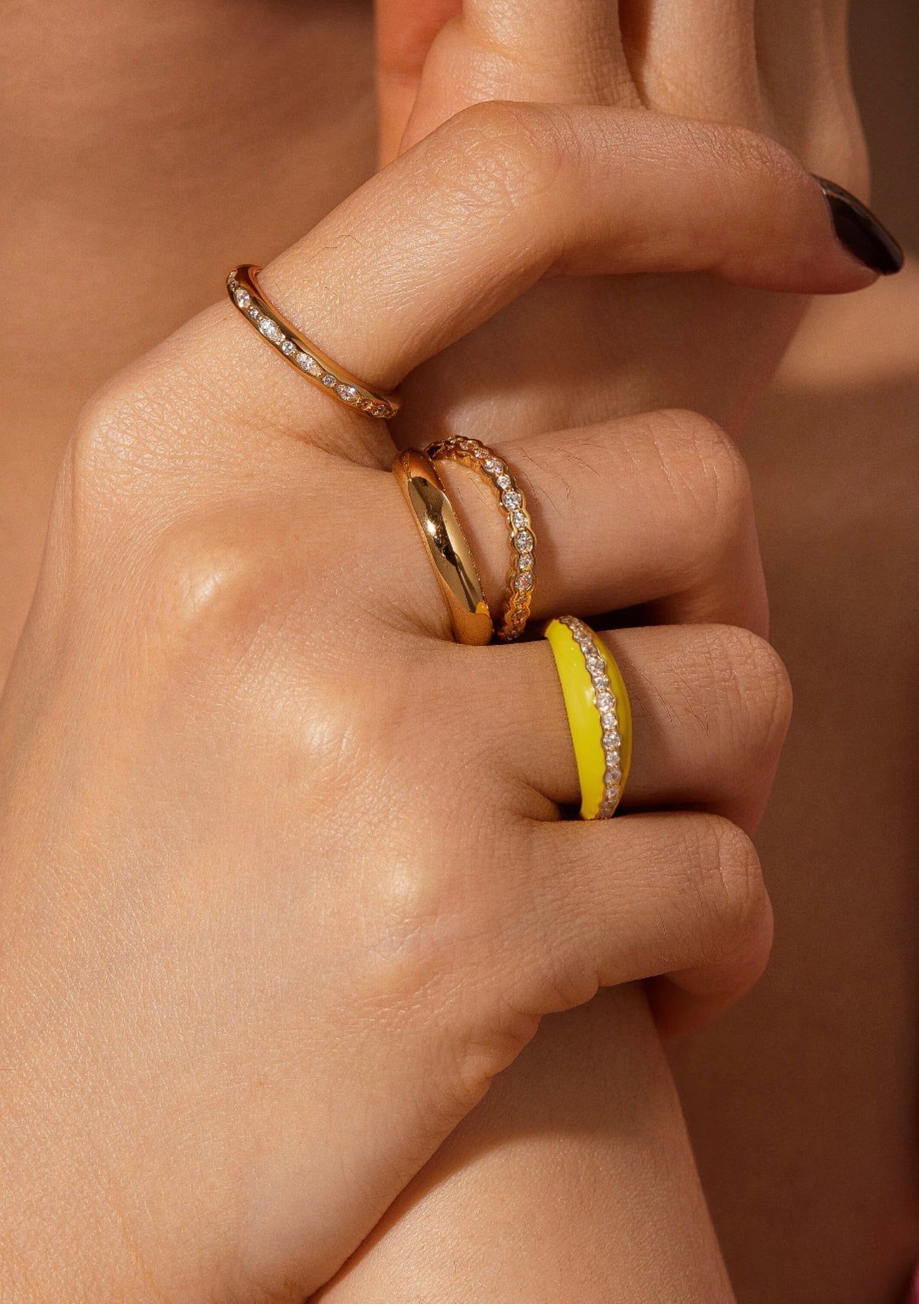 a woman's hand with two rings on it
