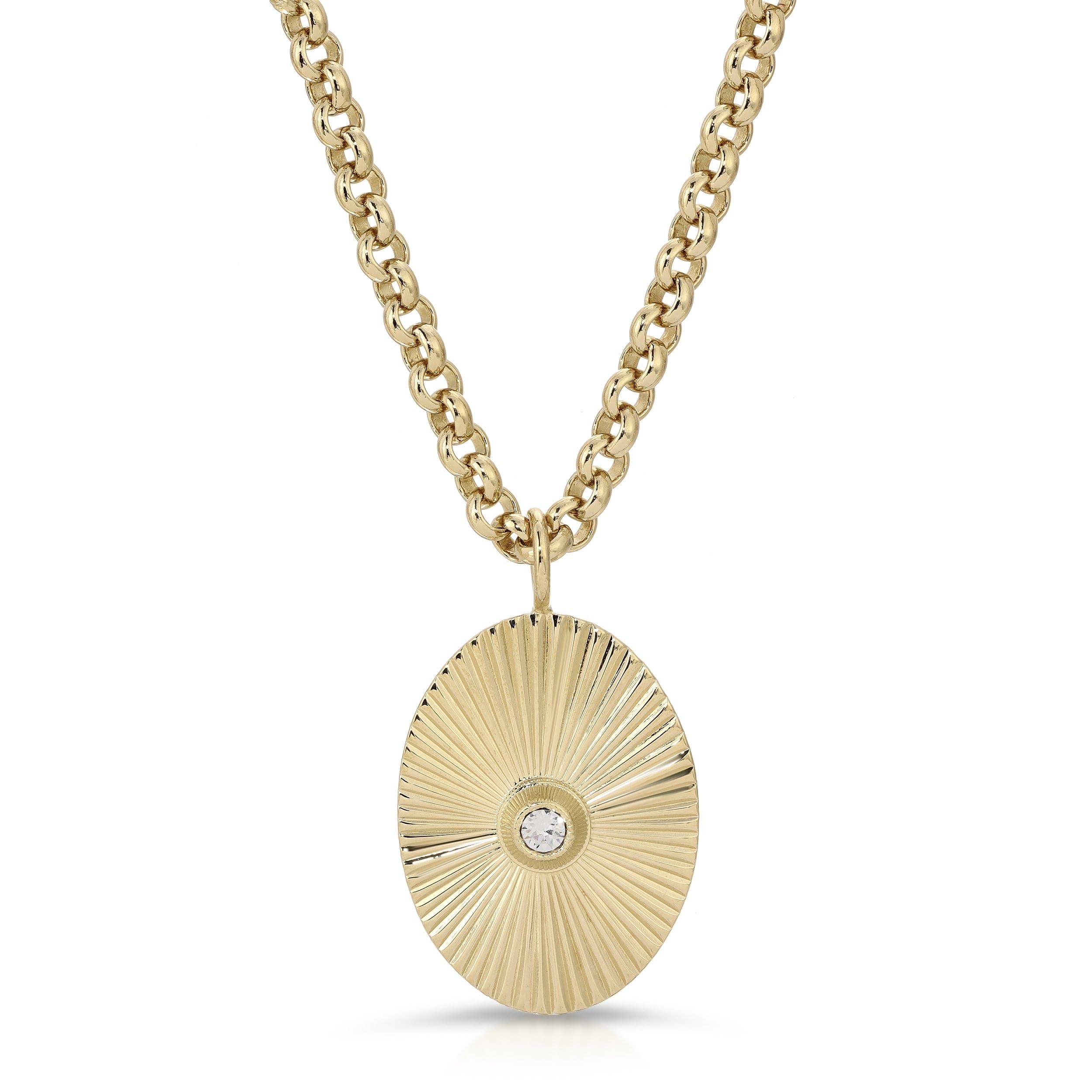 a gold necklace with a diamond in the center
