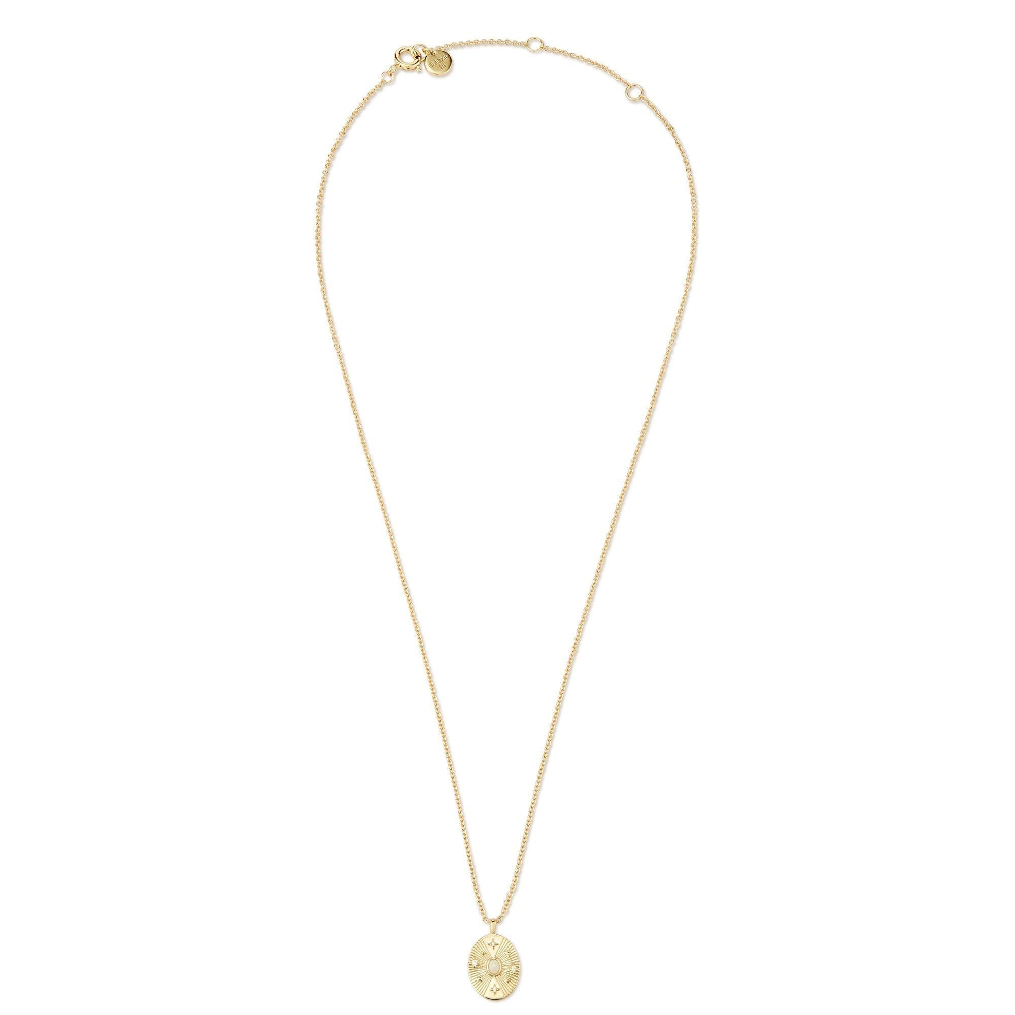 a gold necklace with a coin on it
