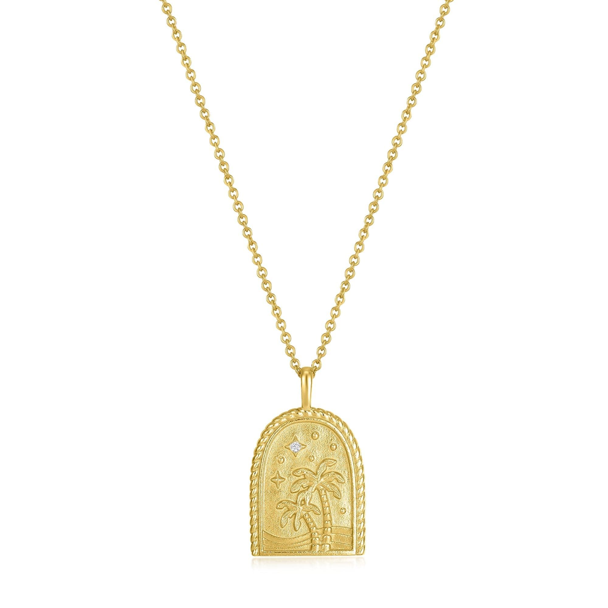 a gold necklace with a palm tree on it