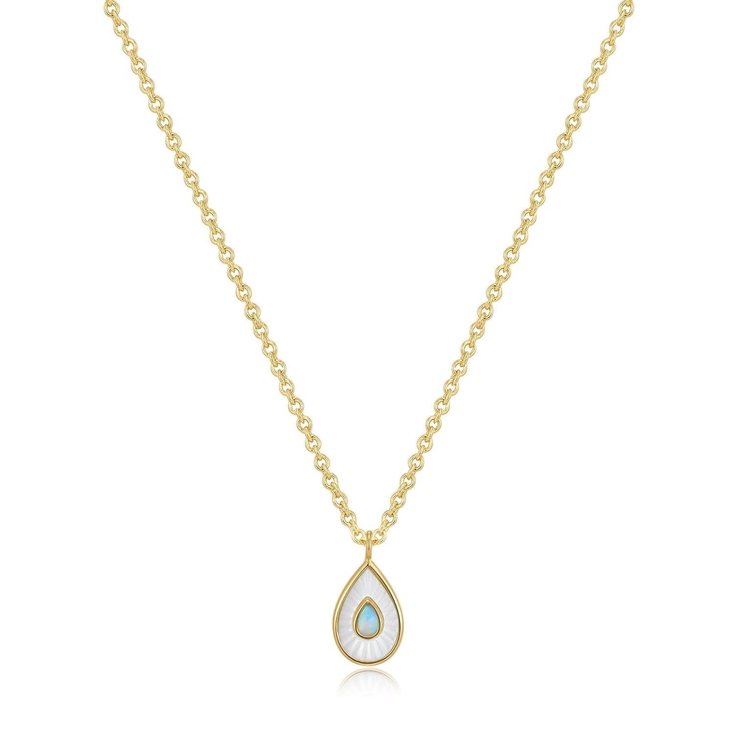 a gold necklace with a tear shaped pendant
