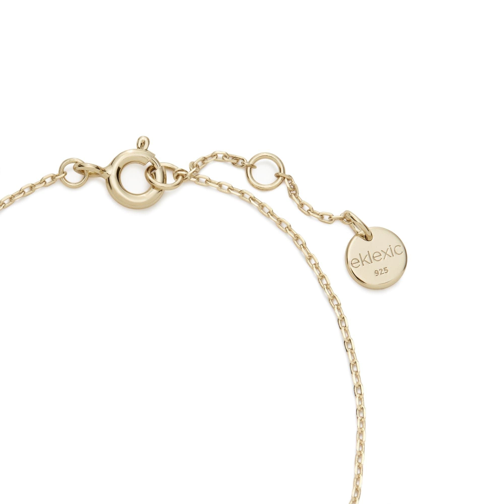a gold bracelet with a circle charm