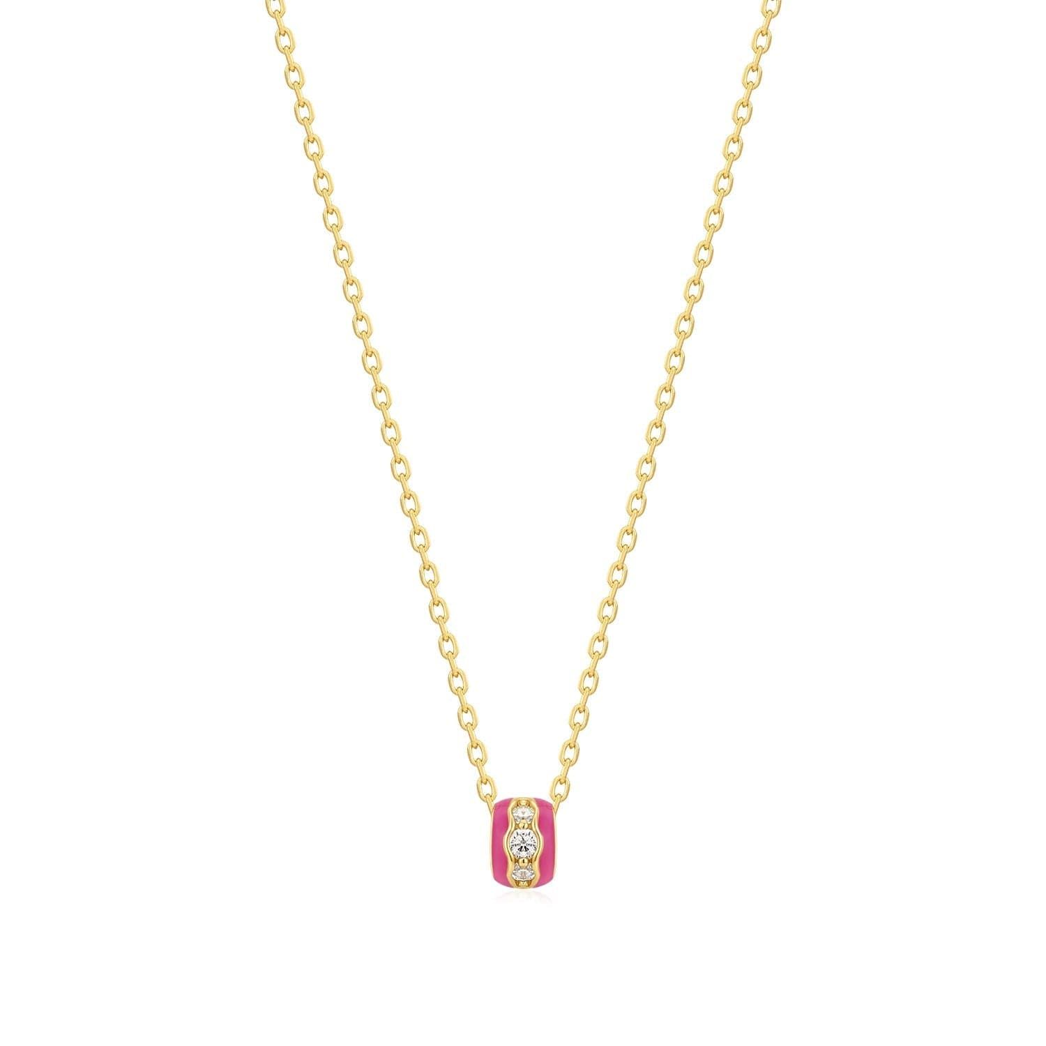 a gold necklace with a pink and yellow pendant