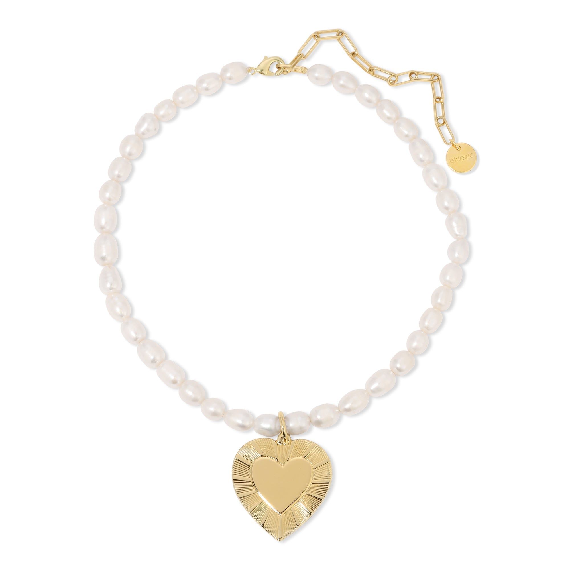 a bracelet with a heart charm and pearls