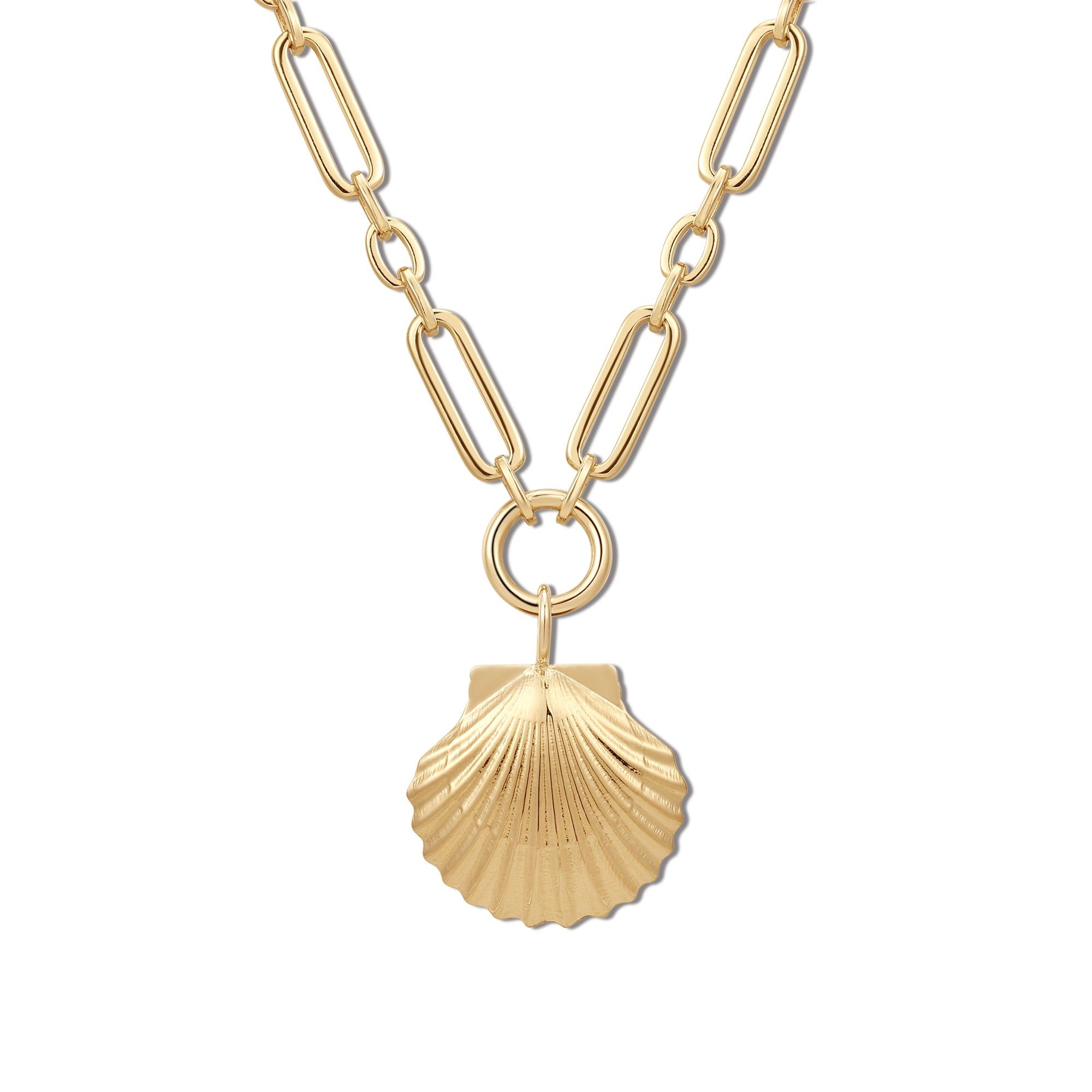 a gold necklace with a shell on it