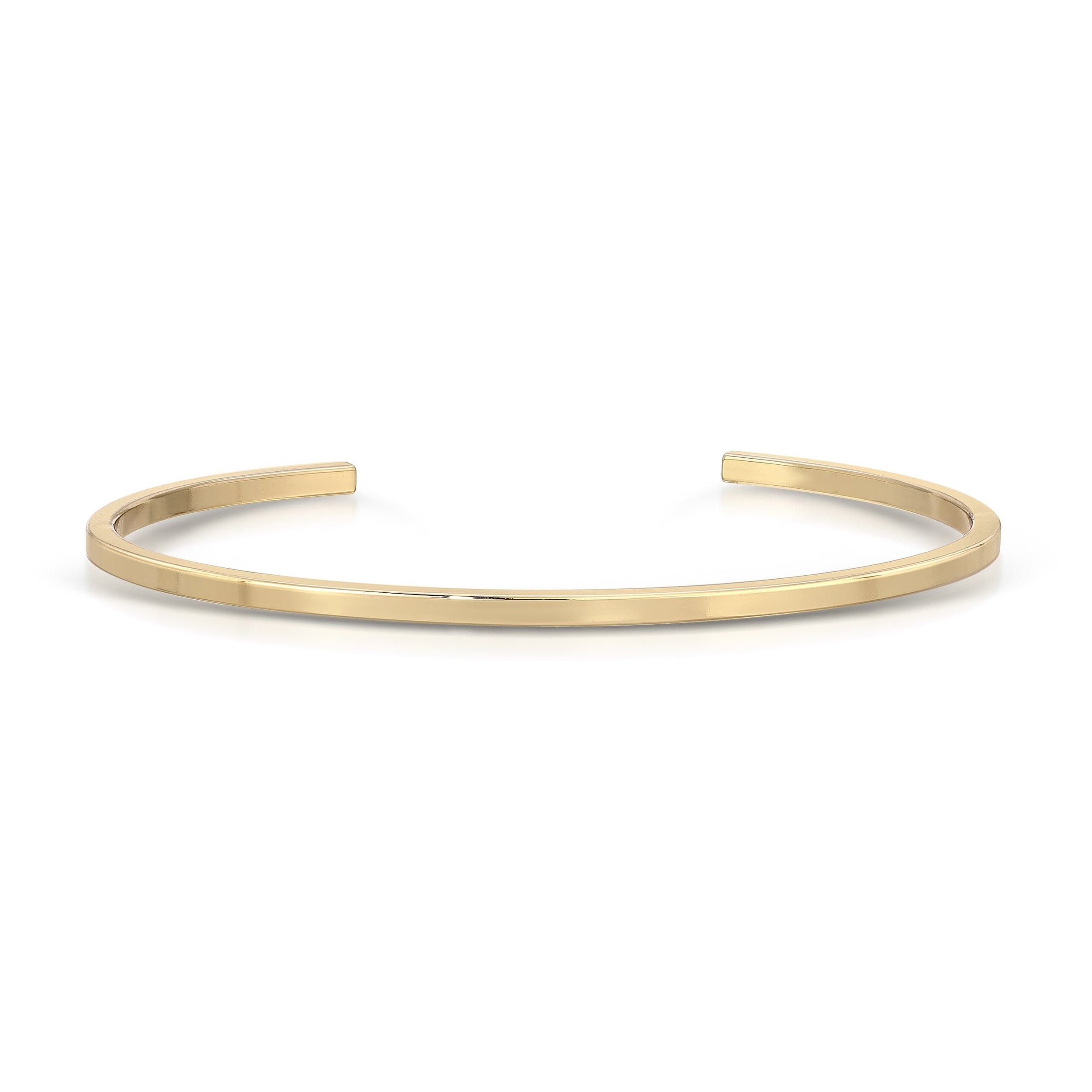 a gold cuff bracelet on a white background