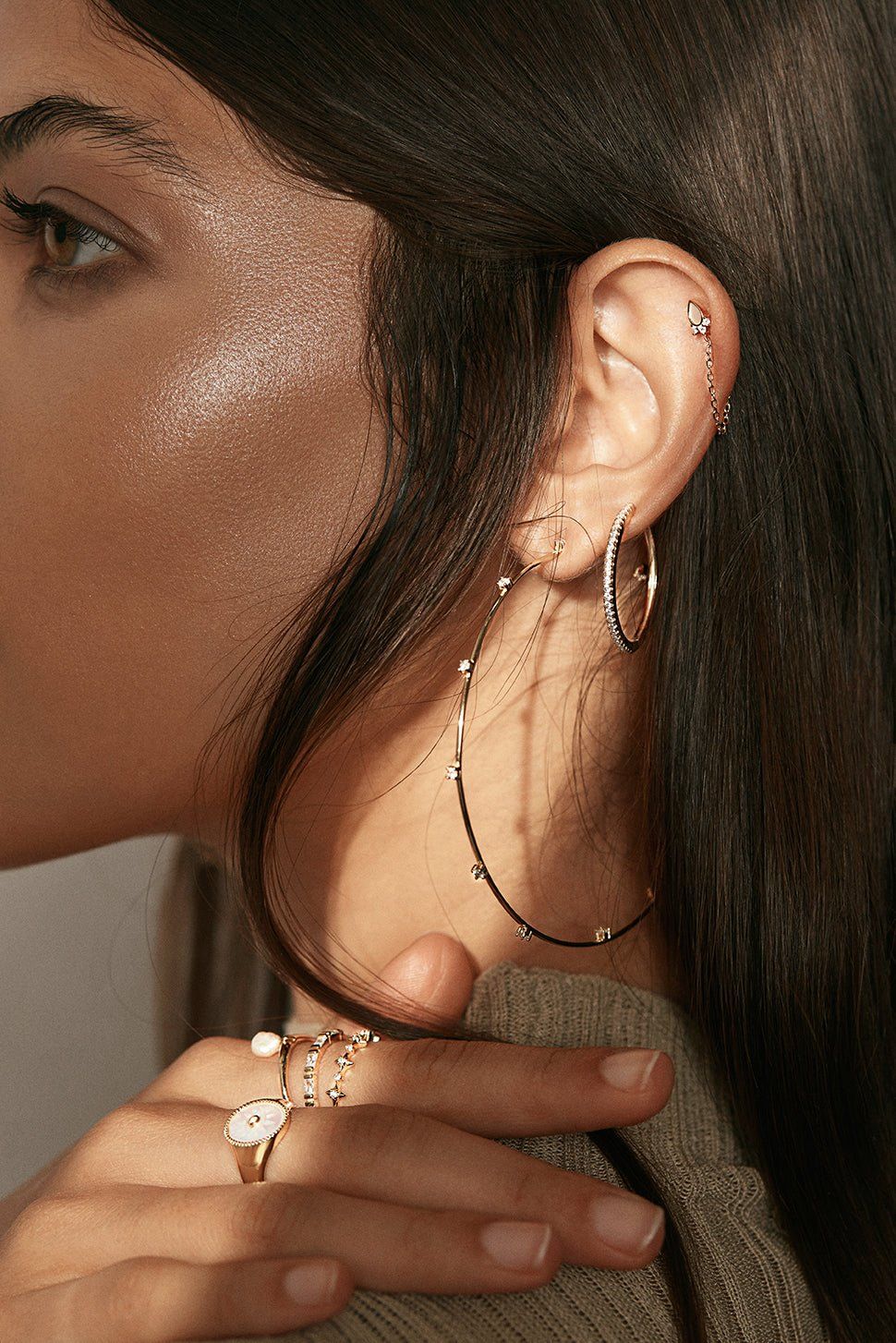 a close up of a person wearing a pair of earrings