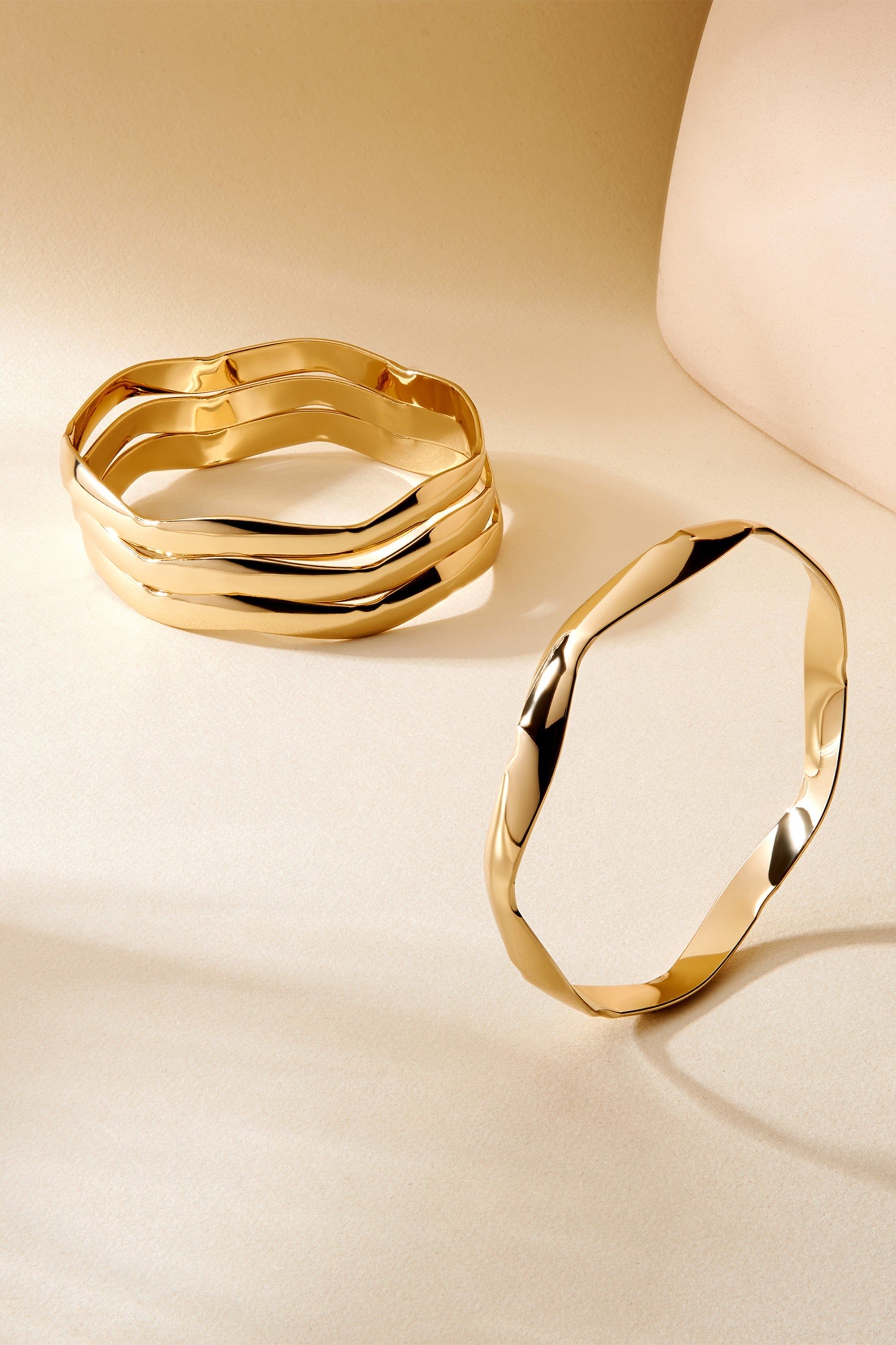 a couple of gold rings sitting on top of a table