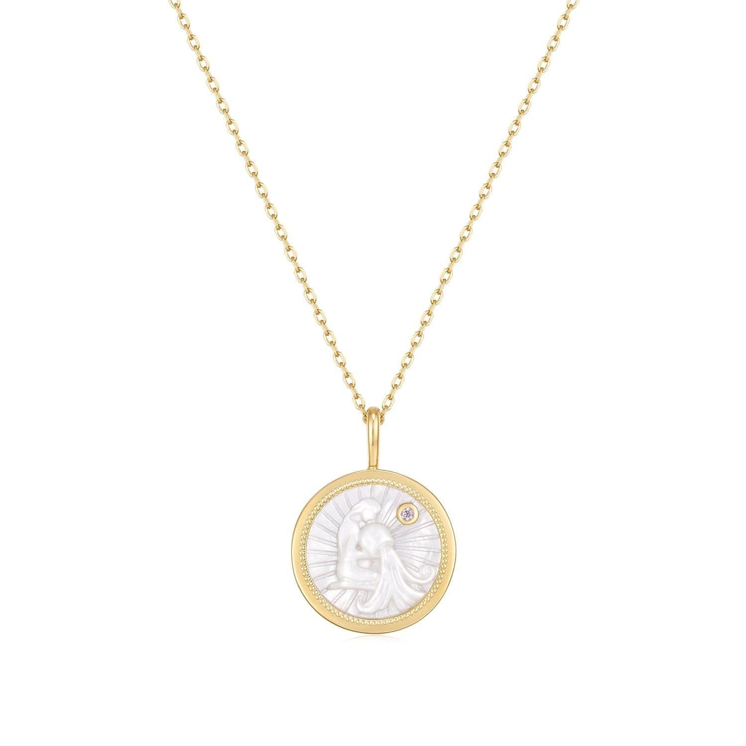a gold necklace with a white face on it