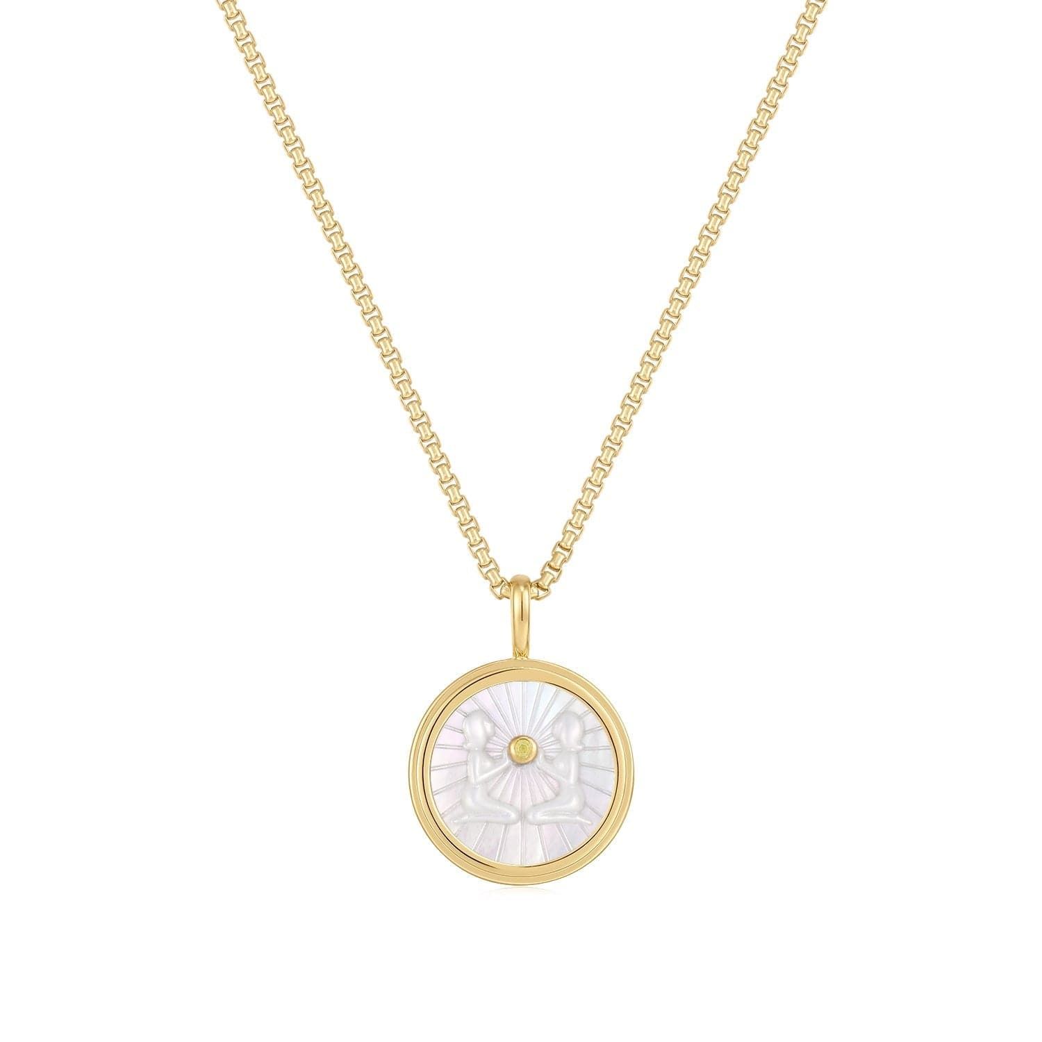 a gold necklace with a mother of pearl in the center
