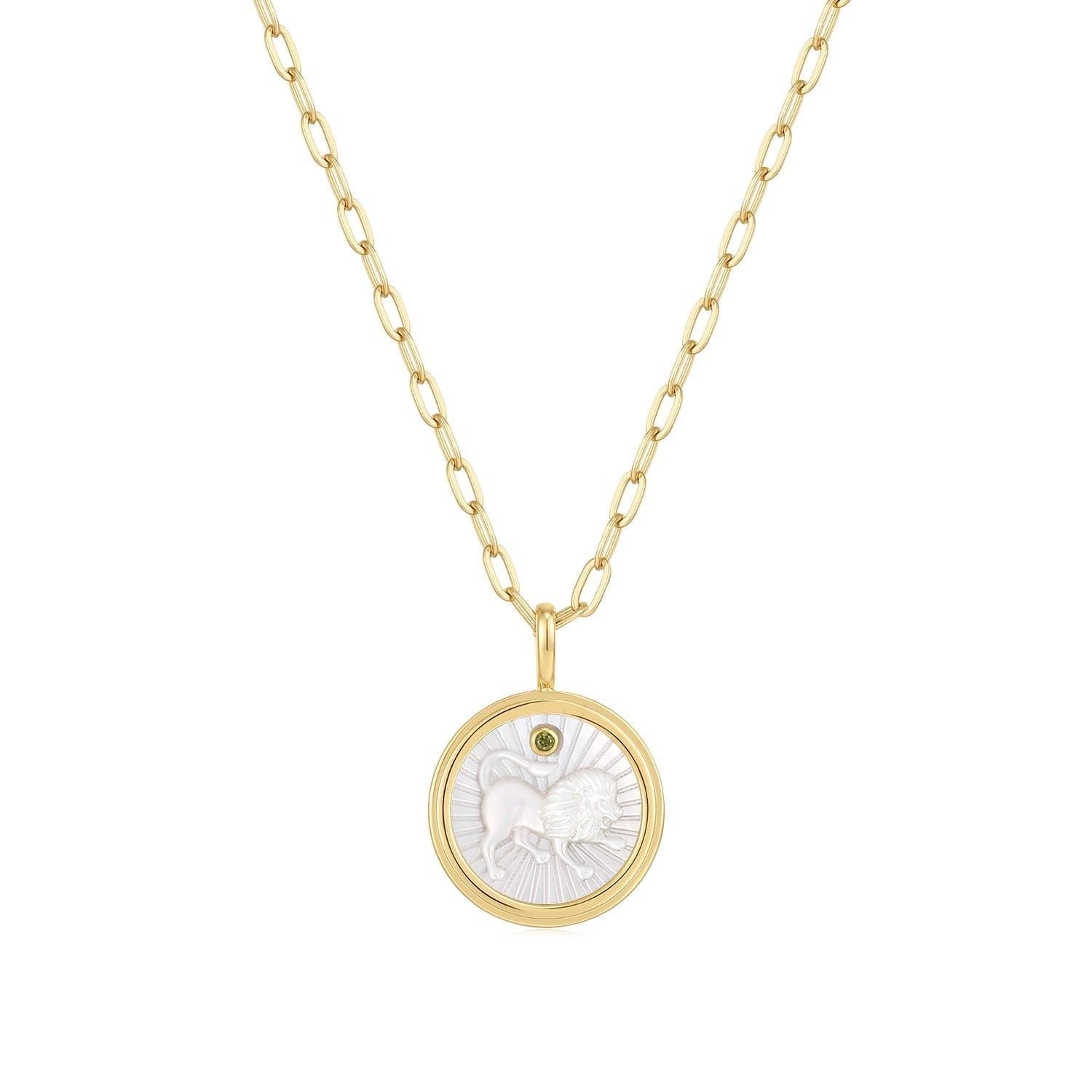 a gold necklace with a white shell on it