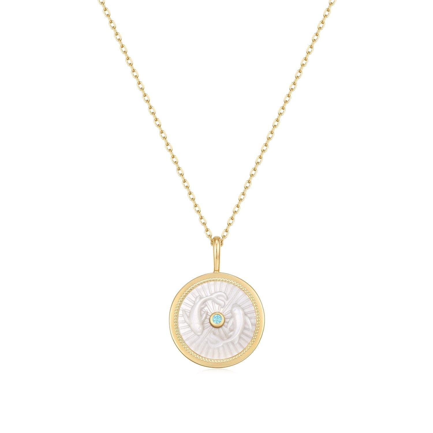 a gold necklace with a white shell on it