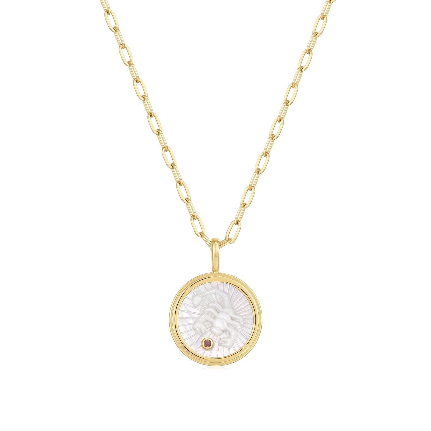 a gold necklace with a mother of pearl in the center